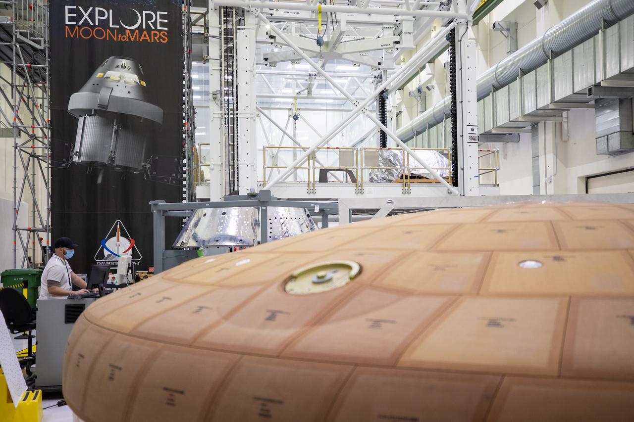 Inside the Neil Armstrong Operations and Checkout Building high bay at NASA's Kennedy Space Center in Florida, technician Russ Novak with ASRC Federal, inspects AVCOAT block bonding on the Artemis II heat shield on July 2, 2020. The heat shield is one of the most critical elements of Orion and will protect the capsule and astronauts during reentry through Earth’s atmosphere. Artemis II is the first crewed mission in a series of missions to the Moon and on to Mars. Artemis II will confirm all of the Orion spacecraft’s systems operate as designed in the actual environment of deep space with astronauts aboard. As part of the Artemis Program, NASA will send the first woman and next man to the Moon by 2024.