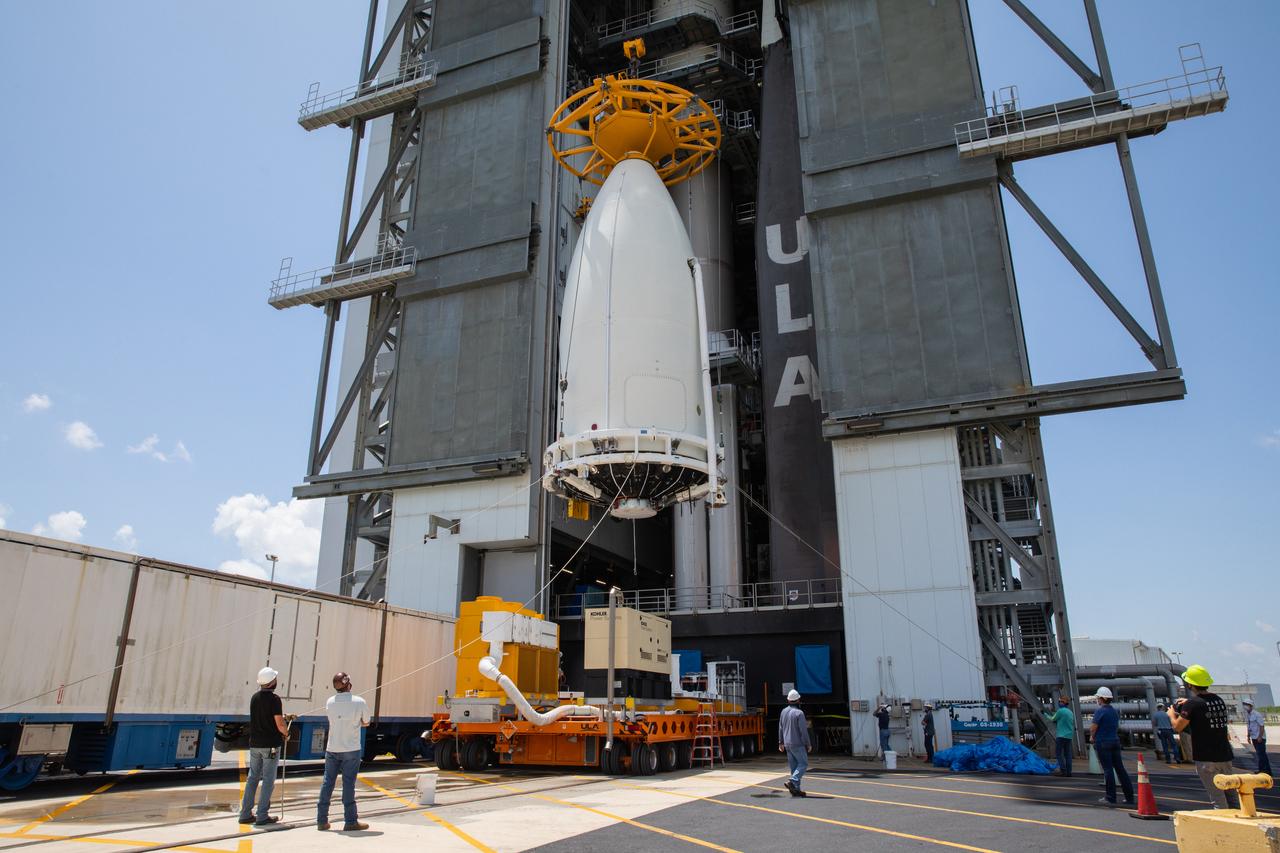 A crane is attached to the United Launch Alliance (ULA) payload fairing with NASA’s Mars 2020 Perseverance rover secured inside at the Vertical Integration Facility (VIF) at Space Launch Complex 41 at Cape Canaveral Air Force Station in Florida on July 7, 2020. Inside the VIF, the payload fairing will be lifted up and secured on the ULA Atlas V rocket. The Mars Perseverance rover is scheduled to launch atop the Atlas V 541 rocket from Pad 41 on July 30. The rover is part of NASA’s Mars Exploration Program, a long-term effort of robotic exploration of the Red Planet. The rover’s seven instruments will search for habitable conditions in the ancient past and signs of past microbial life on Mars. The Launch Services Program at Kennedy is responsible for launch management.
