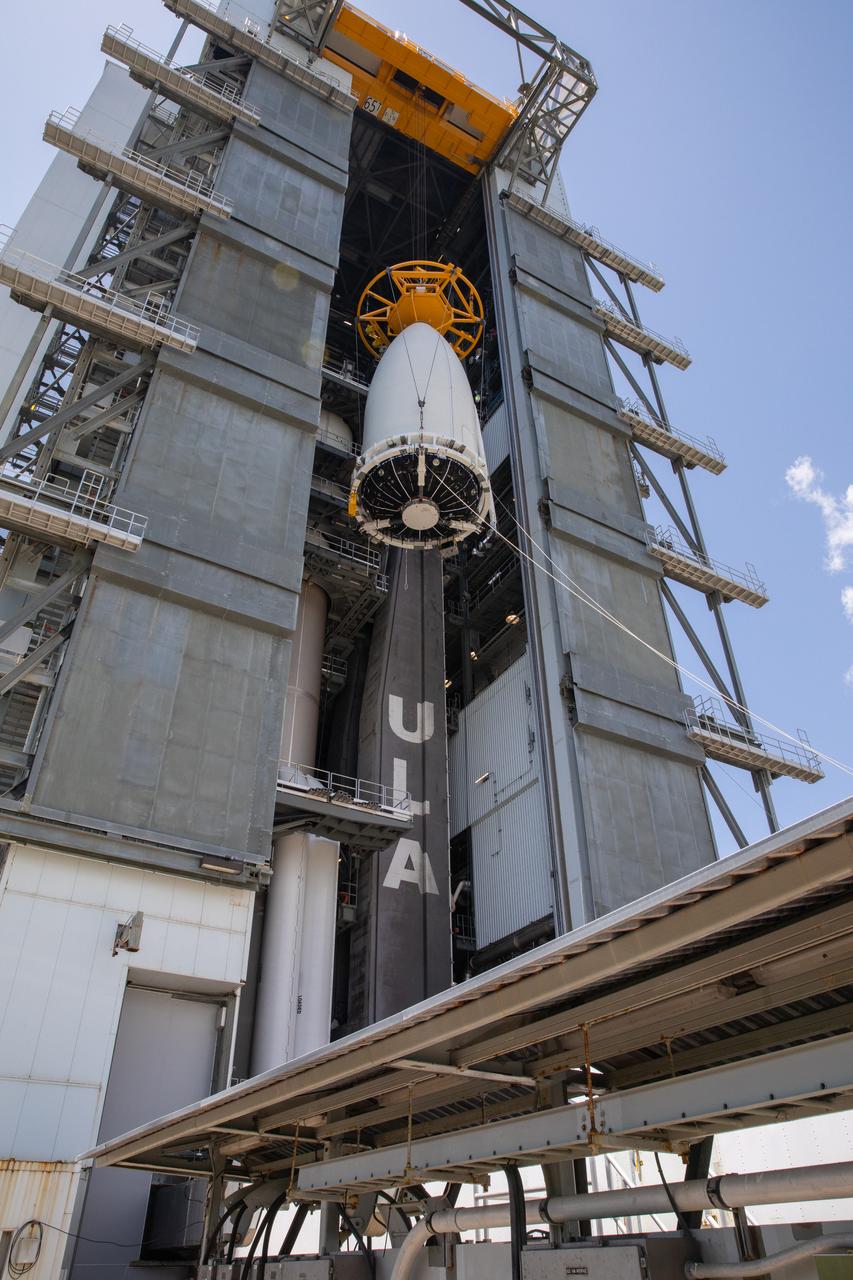 The United Launch Alliance (ULA) payload fairing with NASA’s Mars 2020 Perseverance rover secured inside is lifted high up inside the Vertical Integration Facility (VIF) at Space Launch Complex 41 at Cape Canaveral Air Force Station in Florida on July 7, 2020. Inside the VIF, the payload fairing will be secured on the ULA Atlas V rocket. The Mars Perseverance rover is scheduled to launch atop the Atlas V 541 rocket from Pad 41 on July 30. The rover is part of NASA’s Mars Exploration Program, a long-term effort of robotic exploration of the Red Planet. The rover’s seven instruments will search for habitable conditions in the ancient past and signs of past microbial life on Mars. The Launch Services Program at Kennedy is responsible for launch management.