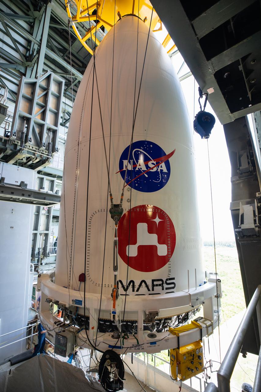 The United Launch Alliance (ULA) payload fairing with NASA’s Mars 2020 Perseverance rover secured inside is positioned on top of the ULA Atlas V rocket inside the Vertical Integration Facility (VIF) at Space Launch Complex 41 at Cape Canaveral Air Force Station in Florida on July 7, 2020. The payload fairing will be secured on the ULA Atlas V rocket. The Mars Perseverance rover is scheduled to launch atop the Atlas V 541 rocket from Pad 41 on July 30. The rover is part of NASA’s Mars Exploration Program, a long-term effort of robotic exploration of the Red Planet. The rover’s seven instruments will search for habitable conditions in the ancient past and signs of past microbial life on Mars. The Launch Services Program at Kennedy is responsible for launch management.