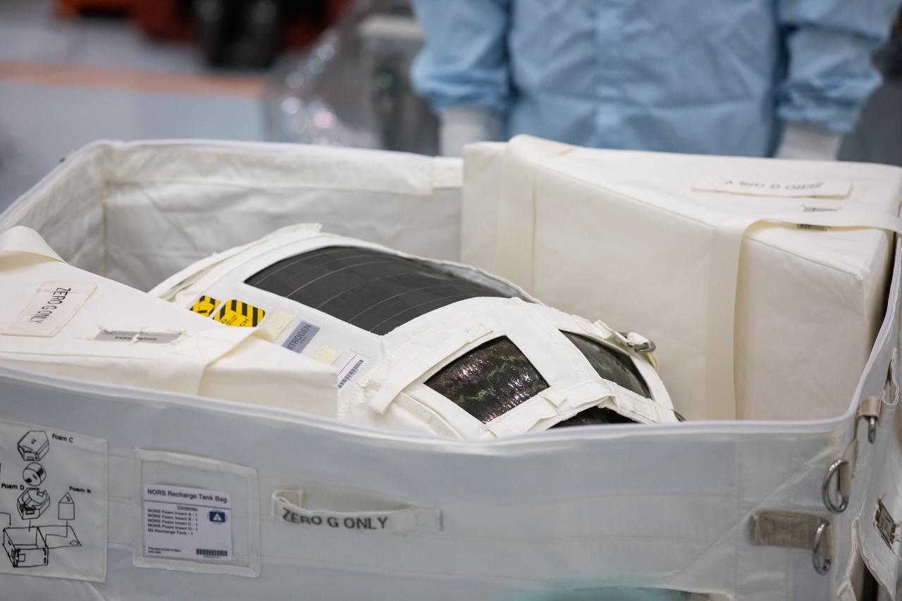A Nitrogen/Oxygen Recharge System (NORS) tank is unpacked and readied for inspection inside the Space Station Processing Facility high bay at NASA’s Kennedy Space Center in Florida on July 16, 2020. The NORS tanks and their support fixtures are designed to connect to the International Space Station’s existing air supply network to refill the previous generation of tanks installed during construction of the space station. These reusable tanks measure 3 feet long and 21 inches in diameter, and weigh about 200 pounds when filled. Once onboard, the tanks will be used to fill the oxygen and nitrogen tanks that supply the needed gases to the space station’s airlock for spacewalks. They could also be used to replenish the atmosphere inside the station. The NORS tanks will launch to the station later in the year on a commercial resupply mission.