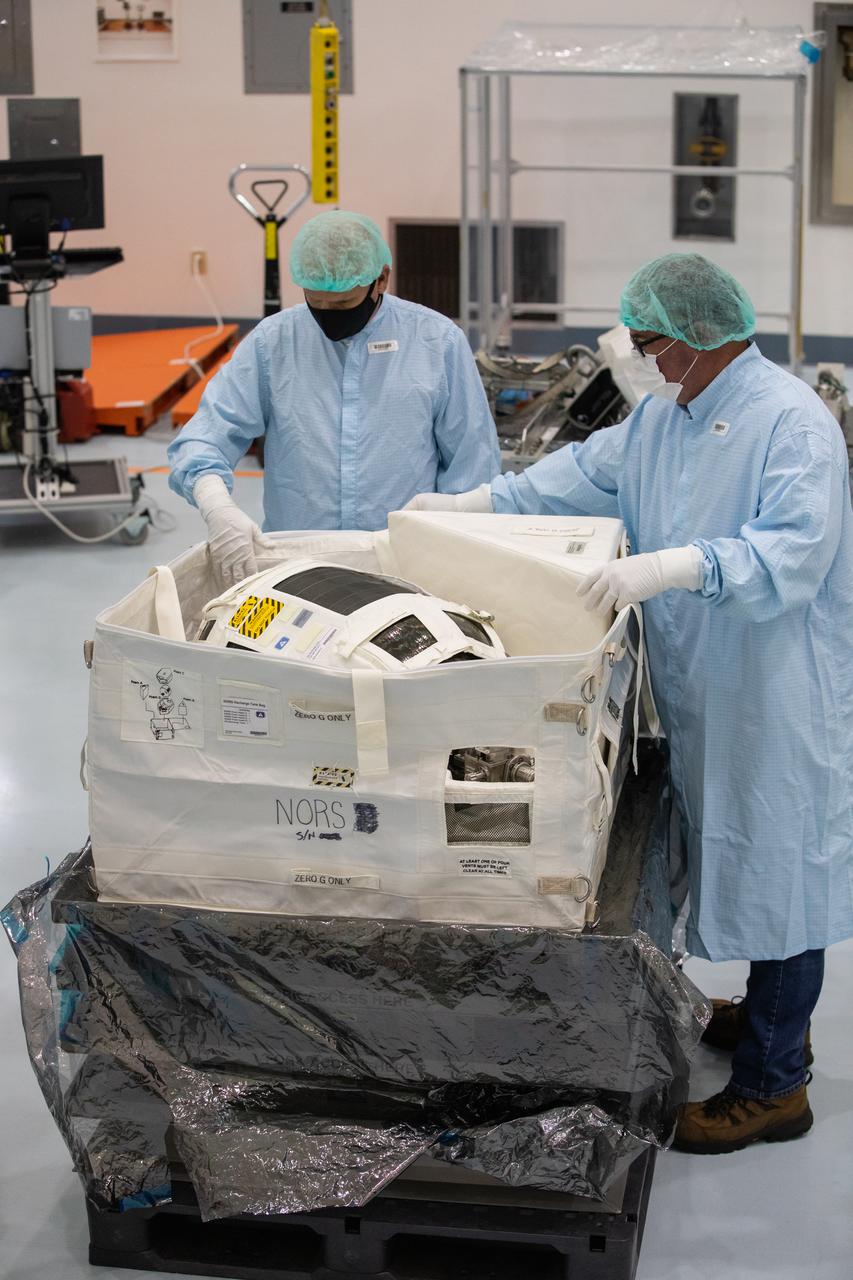 Technicians unpack and inspect a Nitrogen/Oxygen Recharge System (NORS) tank inside the Space Station Processing Facility high bay at NASA’s Kennedy Space Center in Florida on July 16, 2020. The NORS tanks and their support fixtures are designed to connect to the International Space Station’s existing air supply network to refill the previous generation of tanks installed during construction of the space station. These reusable tanks measure 3 feet long and 21 inches in diameter, and weigh about 200 pounds when filled. Once onboard, the tanks will be used to fill the oxygen and nitrogen tanks that supply the needed gases to the space station’s airlock for spacewalks. They could also be used to replenish the atmosphere inside the station. The NORS tanks will launch to the station later in the year on a commercial resupply mission.