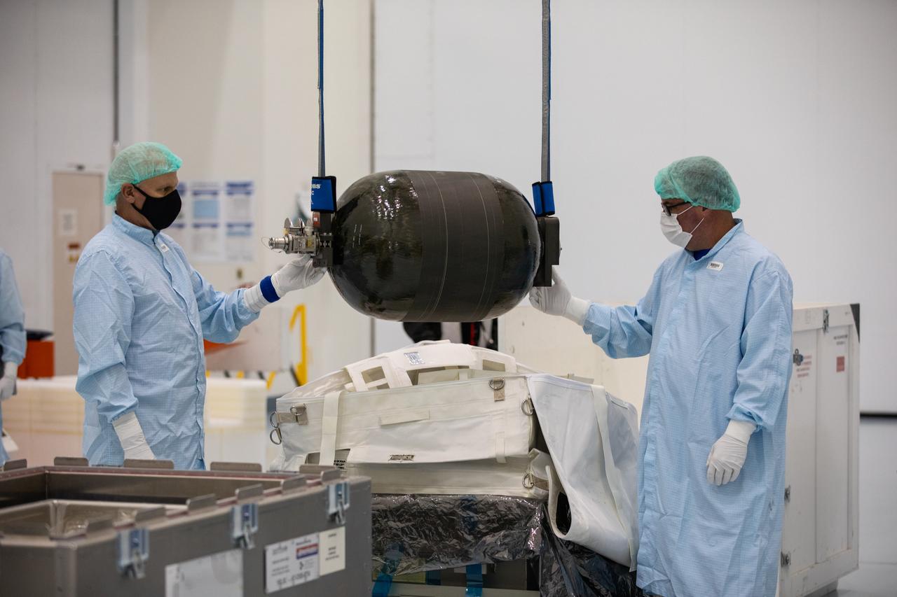 Technicians unpack and inspect a Nitrogen/Oxygen Recharge System (NORS) tank inside the Space Station Processing Facility high bay at NASA’s Kennedy Space Center in Florida on July 16, 2020. The NORS tanks and their support fixtures are designed to connect to the International Space Station’s existing air supply network to refill the previous generation of tanks installed during construction of the space station. These reusable tanks measure 3 feet long and 21 inches in diameter, and weigh about 200 pounds when filled. Once onboard, the tanks will be used to fill the oxygen and nitrogen tanks that supply the needed gases to the space station’s airlock for spacewalks. They could also be used to replenish the atmosphere inside the station. The NORS tanks will launch to the station later in the year on a commercial resupply mission.