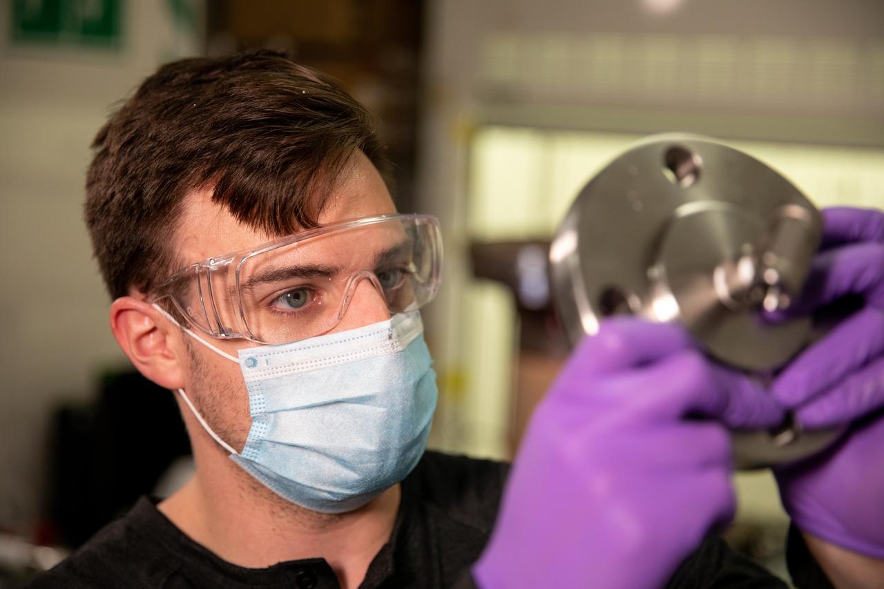 Kevin Grossman, project lead for the Gaseous Lunar Oxygen from Regolith Electrolysis (GaLORE) project at NASA Kennedy Space Center’s Swamp Works, inspects a piece of hardware for GaLORE on July 21, 2020, inside a laboratory at the center’s Neil Armstrong Operations and Checkout Building. Grossman is leading an Early Career Initiative project that is investing in turning lunar regolith into oxygen that could be used for life support for sustainable human lunar exploration on long-duration missions to Mars. GaLORE was selected as an Early Career Initiative project by NASA’s Space Technology Mission directorate.