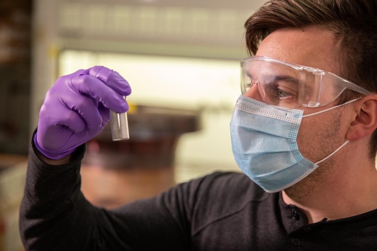 Kevin Grossman, project lead for the Gaseous Lunar Oxygen from Regolith Electrolysis (GaLORE) project at NASA Kennedy Space Center’s Swamp Works, inspects a piece of hardware for GaLORE on July 21, 2020, inside a laboratory at the center’s Neil Armstrong Operations and Checkout Building. Grossman is leading an Early Career Initiative project that is investing in turning lunar regolith into oxygen that could be used for life support for sustainable human lunar exploration on long-duration missions to Mars. GaLORE was selected as an Early Career Initiative project by NASA’s Space Technology Mission directorate.