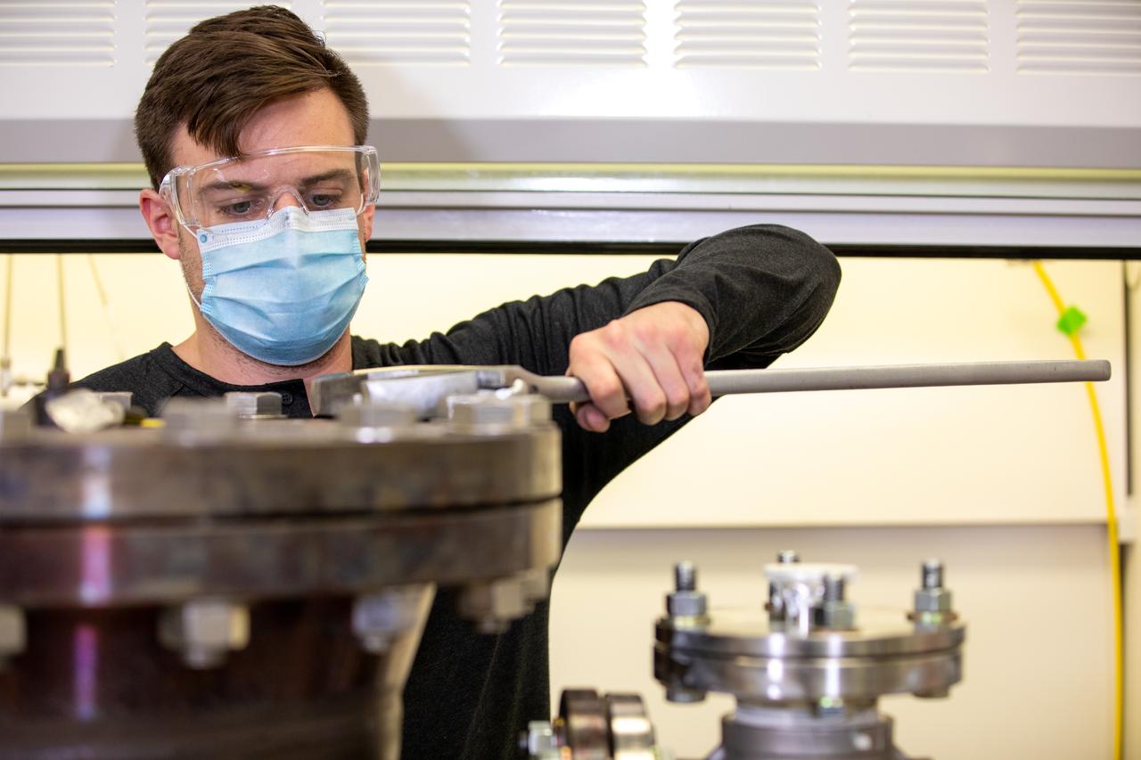 Kevin Grossman, project lead for the Gaseous Lunar Oxygen from Regolith Electrolysis (GaLORE) project at NASA Kennedy Space Center’s Swamp Works, works on the hardware for GaLORE on July 21, 2020, inside a laboratory at the center’s Neil Armstrong Operations and Checkout Building. Grossman is leading an Early Career Initiative project that is investing in turning lunar regolith into oxygen that could be used for life support for sustainable human lunar exploration on long-duration missions to Mars. GaLORE was selected as an Early Career Initiative project by NASA’s Space Technology Mission directorate.