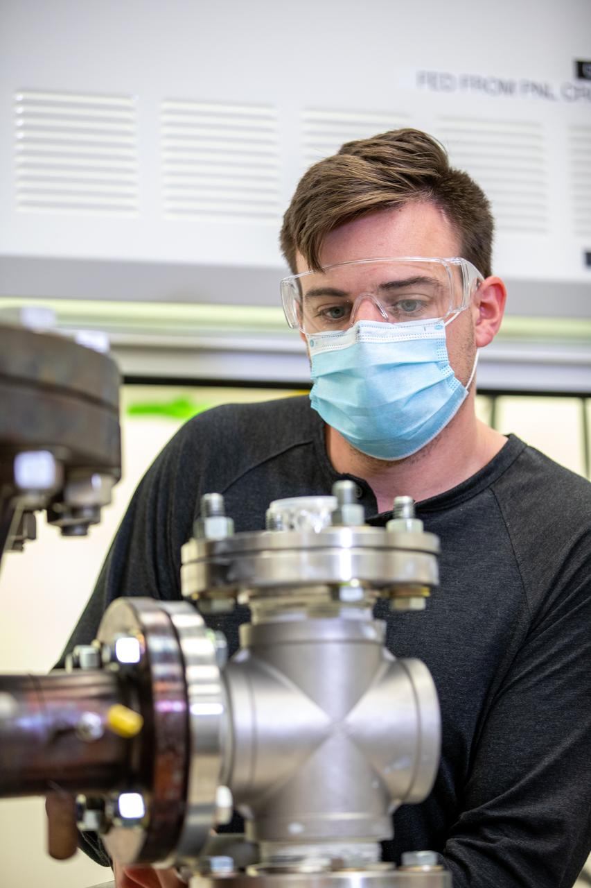 Kevin Grossman, project lead for the Gaseous Lunar Oxygen from Regolith Electrolysis (GaLORE) project at NASA Kennedy Space Center’s Swamp Works, works on the hardware for GaLORE on July 21, 2020, inside a laboratory at the center’s Neil Armstrong Operations and Checkout Building. Grossman is leading an Early Career Initiative project that is investing in turning lunar regolith into oxygen that could be used for life support for sustainable human lunar exploration on long-duration missions to Mars. GaLORE was selected as an Early Career Initiative project by NASA’s Space Technology Mission directorate.