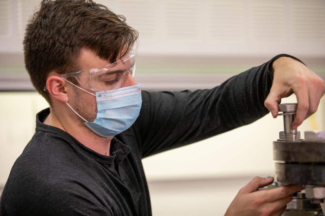 Kevin Grossman, project lead for the Gaseous Lunar Oxygen from Regolith Electrolysis (GaLORE) project at NASA Kennedy Space Center’s Swamp Works, checks the hardware for GaLORE on July 21, 2020, inside a laboratory at the center’s Neil Armstrong Operations and Checkout Building. Grossman is leading an Early Career Initiative project that is investing in turning lunar regolith into oxygen that could be used for life support for sustainable human lunar exploration on long-duration missions to Mars. GaLORE was selected as an Early Career Initiative project by NASA’s Space Technology Mission directorate.