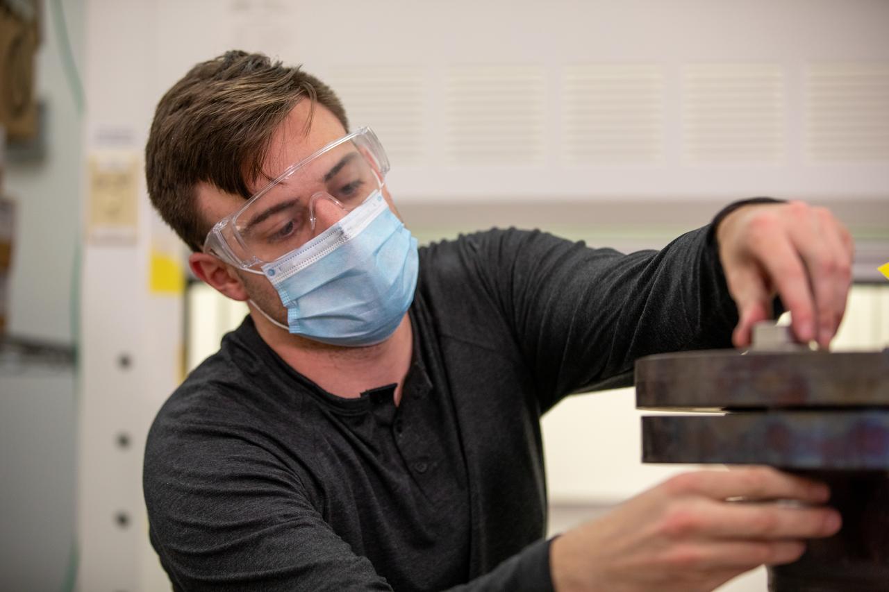 Kevin Grossman, project lead for the Gaseous Lunar Oxygen from Regolith Electrolysis (GaLORE) project at NASA Kennedy Space Center’s Swamp Works, checks the hardware for GaLORE on July 21, 2020, inside a laboratory at the center’s Neil Armstrong Operations and Checkout Building. Grossman is leading an Early Career Initiative project that is investing in turning lunar regolith into oxygen that could be used for life support for sustainable human lunar exploration on long-duration missions to Mars. GaLORE was selected as an Early Career Initiative project by NASA’s Space Technology Mission directorate.