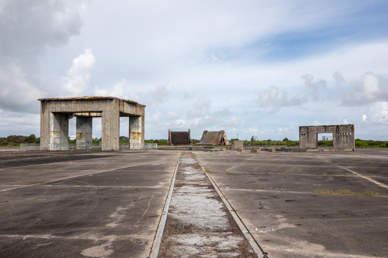 A view of the launch pedestal (at left) still standing at Launch Complex 34 at Cape Canaveral Space Force Station in Florida on July 22, 2020. In the background are two flame deflectors. Work will soon begin to perform environmental contamination removal on the pedestal and the ground area surrounding the launch complex.