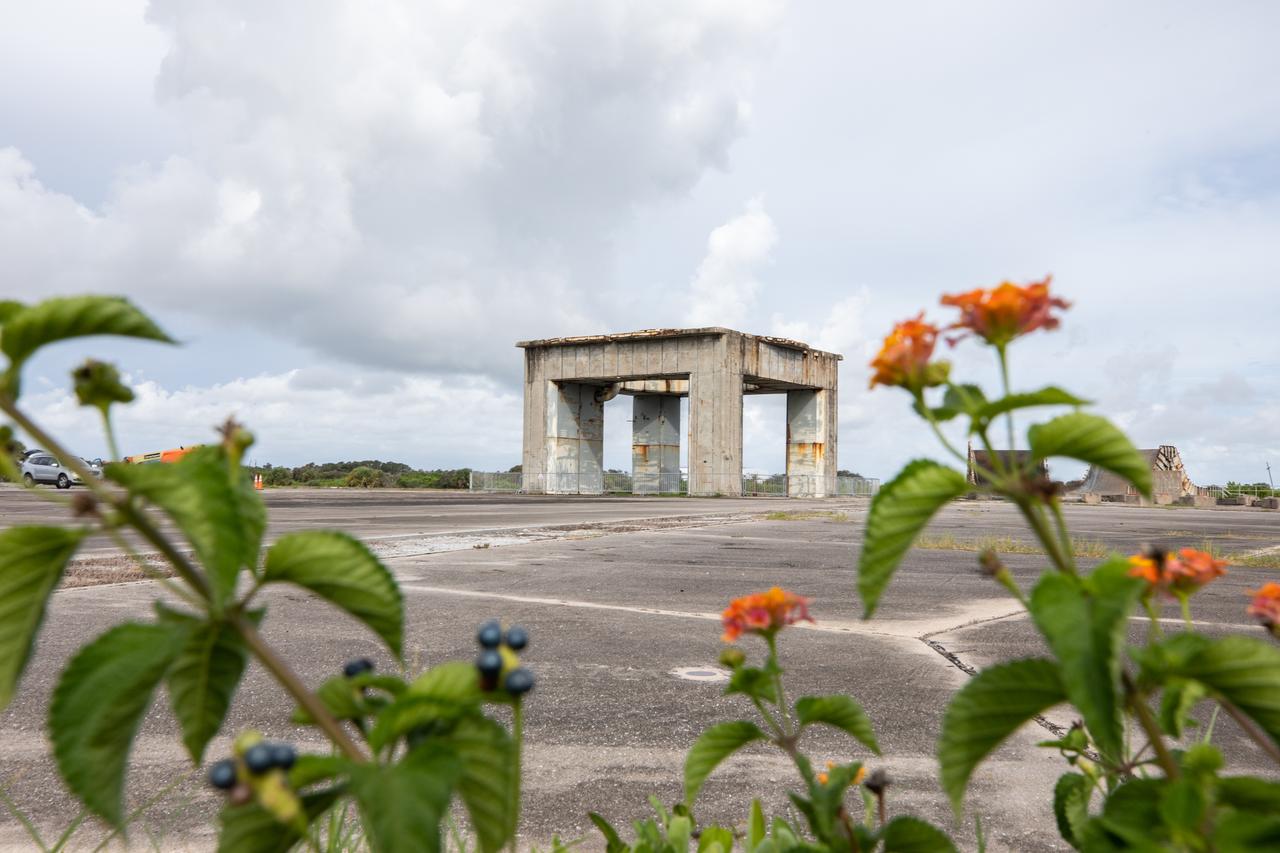 A view of the launch pedestal still standing at Launch Complex 34 with wildflowers in the foreground at Cape Canaveral Space Force Station in Florida on July 22, 2020. Work will soon begin to perform environmental contamination removal on the pedestal and the ground area surrounding the launch complex.