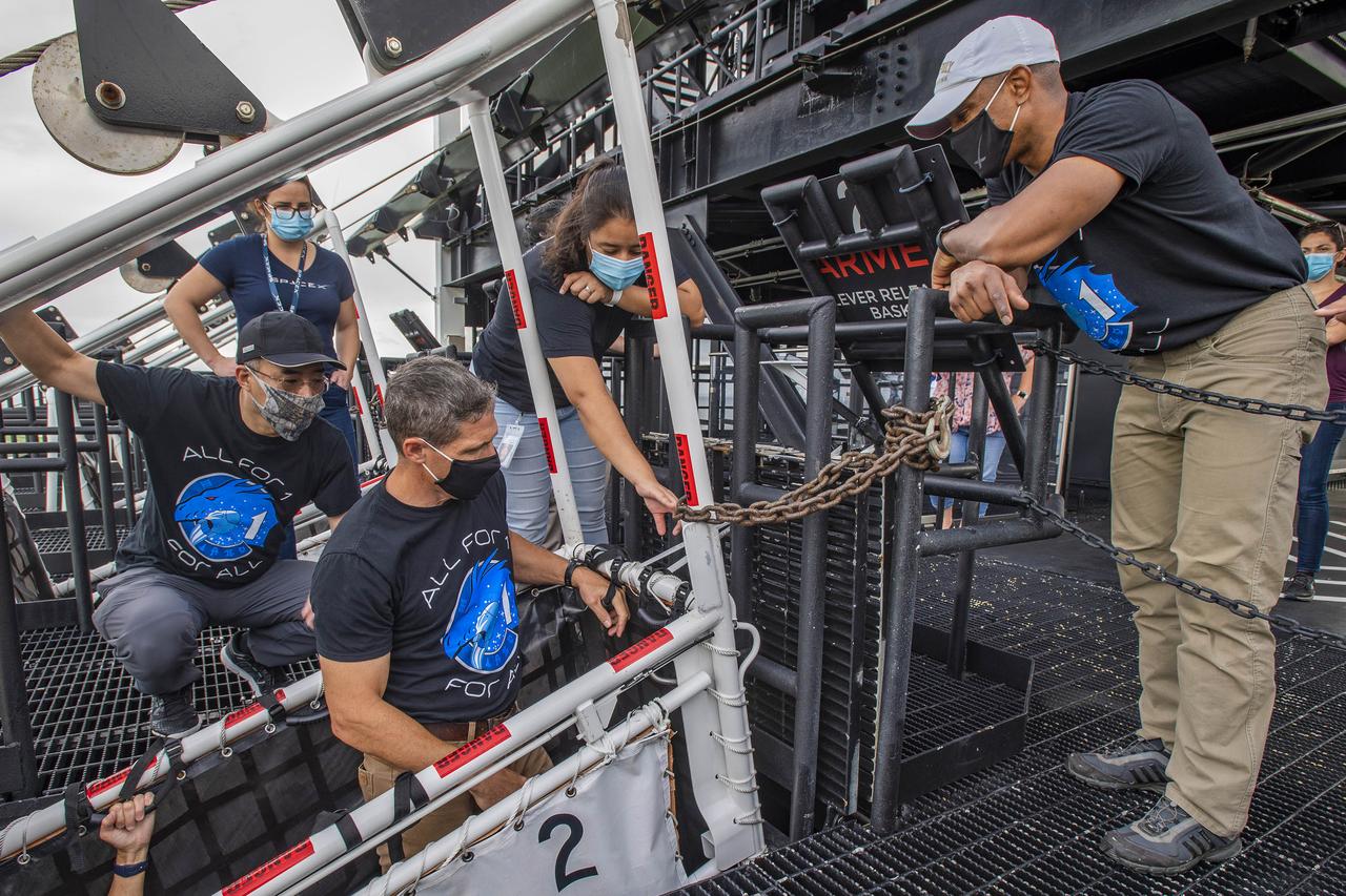 From left, Japan Aerospace Exploration Agency (JAXA) astronaut and mission specialist Soichi Noguchi, and NASA astronauts Michael Hopkins, spacecraft commander, and Victor Glover, pilot, participate in a SpaceX training exercise on July 22, 2020, at the agency’s Kennedy Space Center in Florida in preparation for NASA’s SpaceX Crew-1 mission. Also participating in the training but not pictured was NASA astronaut and mission specialist Shannon Walker. The exercise involved simulating an emergency situation prior to liftoff at Kennedy’s Launch Complex 39A. Crew-1 will be the first operational mission to the International Space Station under NASA’s Commercial Crew Program, following the agency’s certification of SpaceX’s crew transportation system.