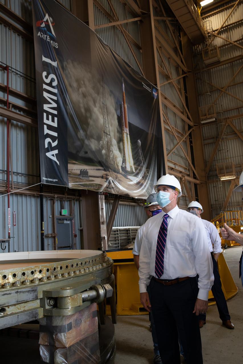 NASA Administrator Jim Bridenstine views Artemis I booster hardware inside the Rotation, Processing and Surge Facility at NASA’s Kennedy Space Center in Florida on July 27, 2020. Manufactured by Northrop Grumman in Utah, the boosters for the agency’s Space Launch System (SLS) rocket are now undergoing prelaunch processing at Kennedy. During launch, the twin boosters will provide more than 75 percent of the total SLS thrust. The first in a series of increasingly complex missions, Artemis I will test the Orion spacecraft and SLS as an integrated system ahead of crewed flights to the Moon.