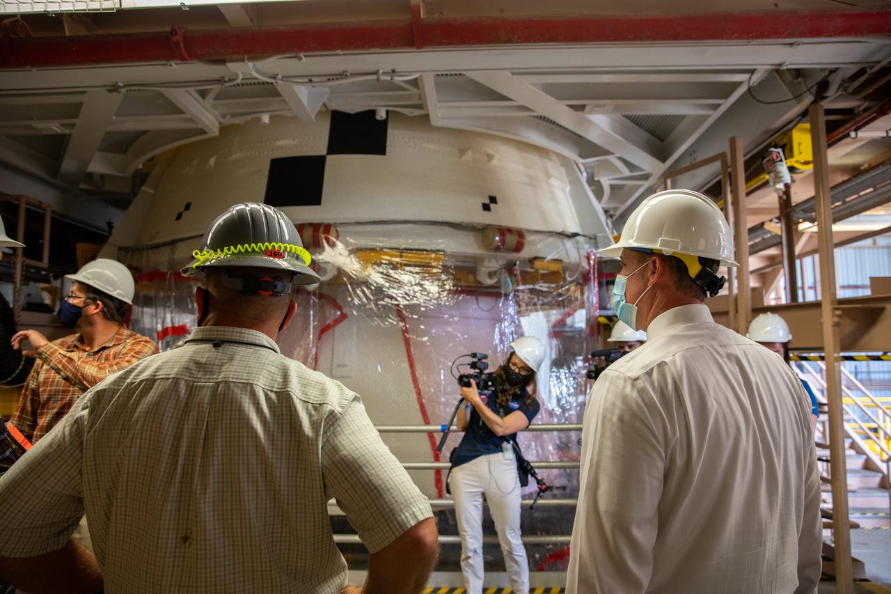 NASA Administrator Jim Bridenstine (right), accompanied by Jacobs employees, views Artemis I booster hardware inside the Rotation, Processing and Surge Facility at NASA’s Kennedy Space Center in Florida on July 27, 2020. Manufactured by Northrop Grumman in Utah, the boosters for the agency’s Space Launch System (SLS) rocket are now undergoing prelaunch processing at Kennedy. During launch, the twin boosters will provide more than 75 percent of the total SLS thrust. The first in a series of increasingly complex missions, Artemis I will test the Orion spacecraft and SLS as an integrated system ahead of crewed flights to the Moon.  