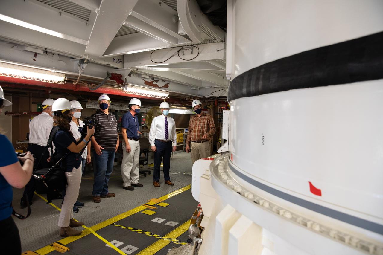 NASA Administrator Jim Bridenstine (second from right), accompanied by Jacobs and Exploration Ground Systems employees, views Artemis I booster hardware inside the Rotation, Processing and Surge Facility at NASA’s Kennedy Space Center in Florida on July 27, 2020. Manufactured by Northrop Grumman in Utah, the boosters for the agency’s Space Launch System (SLS) rocket are now undergoing prelaunch processing at Kennedy. During launch, the twin boosters will provide more than 75 percent of the total SLS thrust. The first in a series of increasingly complex missions, Artemis I will test the Orion spacecraft and SLS as an integrated system ahead of crewed flights to the Moon.  
