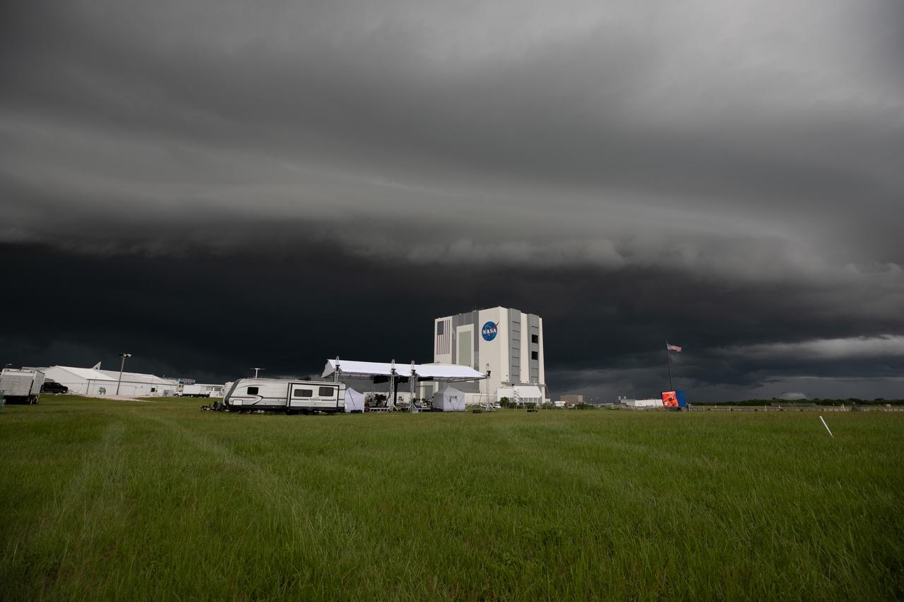 From NASA Kennedy Space Center’s Press Site lawn near the iconic countdown clock, storm clouds can be seen rolling in over the Vehicle Assembly Building (VAB) on July 28, 2020. Standing at 525 feet tall, this facility is capable of hosting multiple varieties of rockets and spacecraft at the same time. Currently, the VAB is being utilized to process and assemble the agency’s Space Launch System (SLS) rocket for Artemis missions to the Moon and beyond to Mars. Artemis I – the first launch under the agency’s Artemis Program – will test SLS and Orion as an integrated system prior to crewed flights to the Moon.