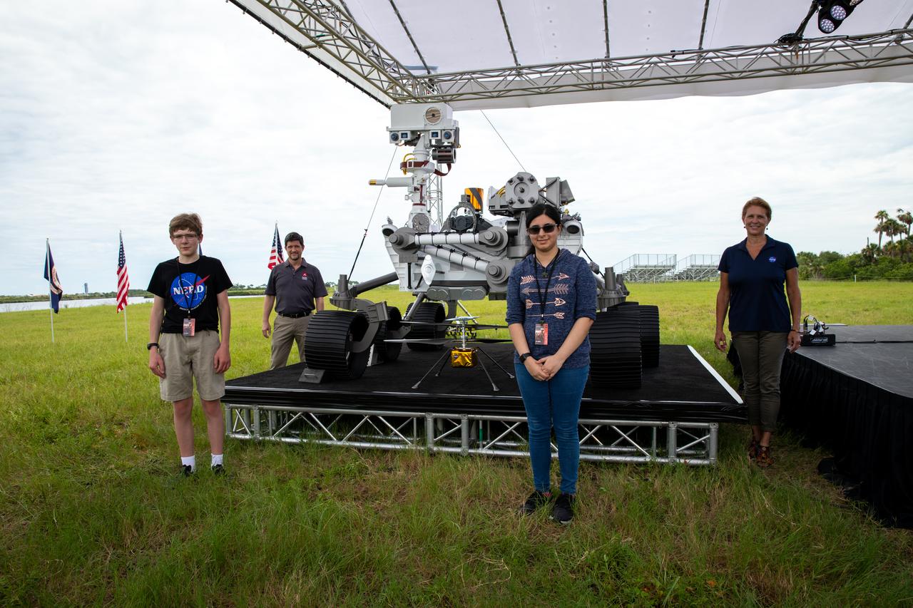 Students Alex Mather, at left, and Vaneeza Rupani, stand in front of a full-scale mock-up of the Mars Perseverance rover at the News Center at NASA’s Kennedy Space Center in Florida on July 28, 2020. Mather named the Perseverance rover, and Rupani named the Ingenuity helicopter. Behind them, at left is George Tahu, Mars 2020 program executive with NASA, and at right is Lori Glaze, planetary science director with NASA. The rover is scheduled to launch July 30, on a United Launch Alliance Atlas V 541 rocket from Space Launch Complex 41 at nearby Cape Canaveral Air Force Station. The rover is part of NASA’s Mars Exploration Program, a long-term effort of robotic exploration of the Red Planet. The rover will search for habitable conditions in the ancient past and signs of past microbial life on Mars. The Launch Services Program at Kennedy is responsible for launch management.