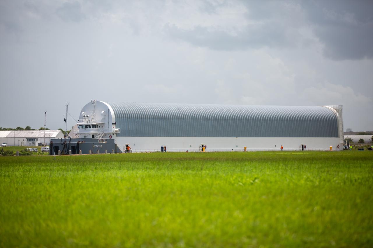 NASA’s Pegasus barge, carrying the launch vehicle stage adapter (LVSA) for the agency’s Space Launch System (SLS) rocket, arrives at the Kennedy Space Center Launch Complex 39 turn basin wharf on July 29, 2020. Traveling to Florida from NASA’s Marshall Space Flight Center in Huntsville, Alabama, the LVSA will connect the SLS core stage to the rocket’s upper stage for the Artemis I launch. Once the LVSA is offloaded, it will be moved to High Bay 4 in the Vehicle Assembly Building for processing ahead of launch. The first launch under the agency’s Artemis program, Artemis I will test SLS and the Orion spacecraft as an integrated system prior to crewed flights to the Moon.
