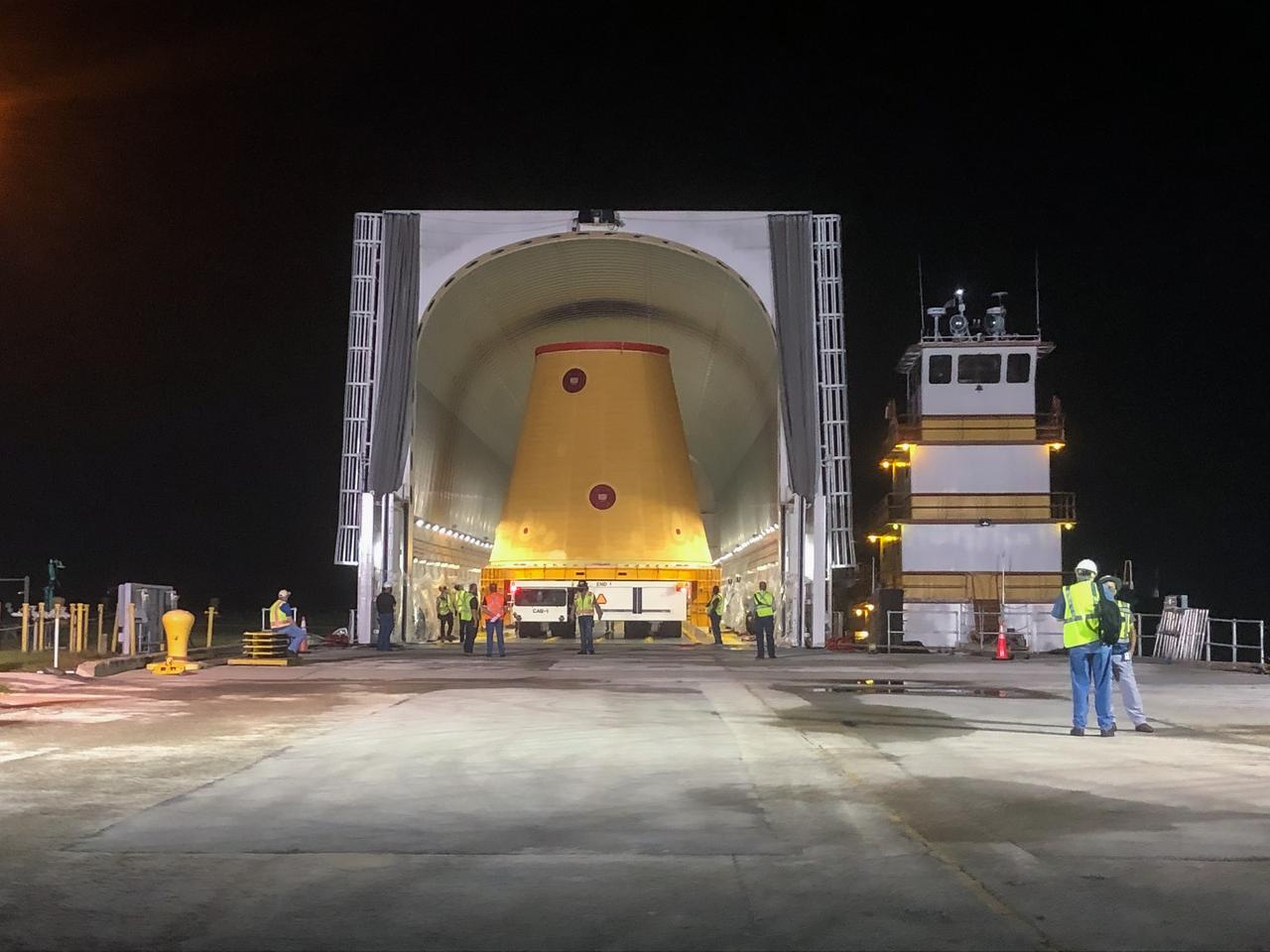 Technicians with NASA’s Exploration Ground Systems prepare to offload the launch vehicle stage adapter (LVSA) for the agency’s Space Launch System (SLS) rocket and move it to the Vehicle Assembly Building (VAB) at NASA’s Kennedy Space Center in Florida on July 30, 2020, for processing. Carried by NASA’s Pegasus barge, the LVSA arrived at Kennedy’s Launch Complex 39 turn basin wharf after departing from the agency’s Marshall Space Flight Center in Huntsville, Alabama. The LVSA will connect the SLS core stage to the rocket’s upper stage and will remain in the VAB until it’s time for stacking on the mobile launcher ahead of the Artemis I launch. The first in a series of increasingly complex missions, Artemis I will test SLS and the Orion spacecraft as an integrated system prior to crewed flights to the Moon.