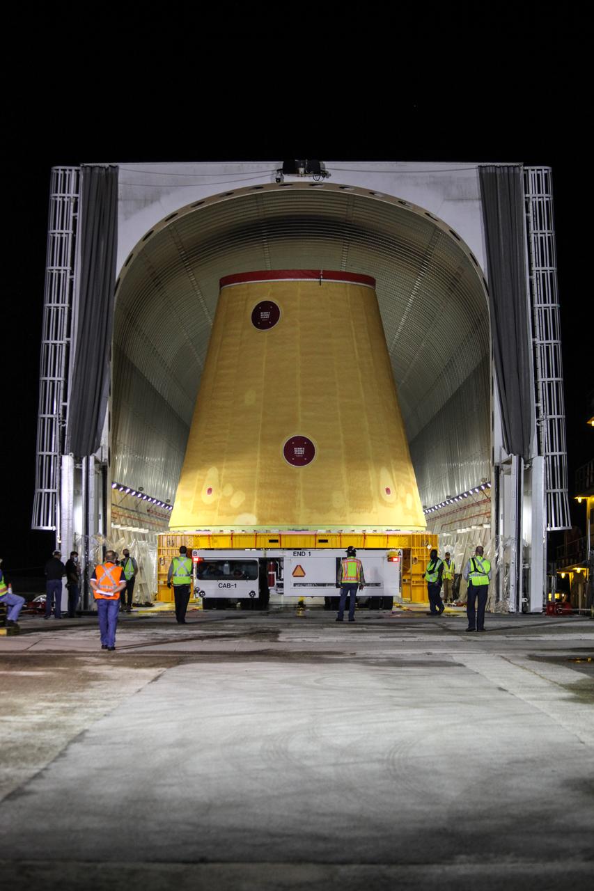 Technicians with NASA’s Exploration Ground Systems begin to offload the launch vehicle stage adapter (LVSA) for the agency’s Space Launch System (SLS) rocket and move it to the Vehicle Assembly Building (VAB) at NASA’s Kennedy Space Center in Florida on July 30, 2020, for processing. Carried by NASA’s Pegasus barge, the LVSA arrived at Kennedy’s Launch Complex 39 turn basin wharf after departing from the agency’s Marshall Space Flight Center in Huntsville, Alabama. The LVSA will connect the SLS core stage to the rocket’s upper stage and will remain in the VAB until it’s time for stacking on the mobile launcher ahead of the Artemis I launch. The first in a series of increasingly complex missions, Artemis I will test SLS and the Orion spacecraft as an integrated system prior to crewed flights to the Moon.