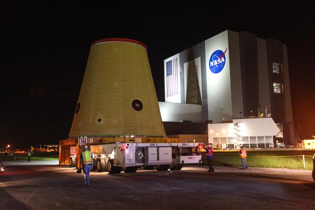 Technicians with NASA’s Exploration Ground Systems move the launch vehicle st...