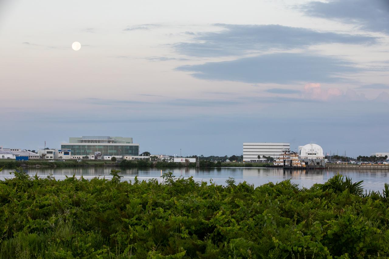 NASA’s Pegasus barge, seen off toward the right, prepares to depart from the agency’s Kennedy Space Center in Florida on Aug. 4, 2020, for its trip to NASA’s Michoud Assembly Facility in Louisiana. The Pegasus barge arrived at Kennedy on July 29, delivering the launch vehicle stage adapter (LVSA) for the agency’s Space Launch System (SLS) rocket – the most powerful rocket NASA has ever built, providing the muscle necessary to get to the Moon and eventually to Mars. The LVSA – now undergoing processing inside the Vehicle Assembly Building – will connect the core stage of the rocket to the upper stage. The next time the Pegasus barge returns to Kennedy, it will be carrying the SLS core stage – the final piece of the rocket that needs to be delivered ahead of the Artemis I launch.