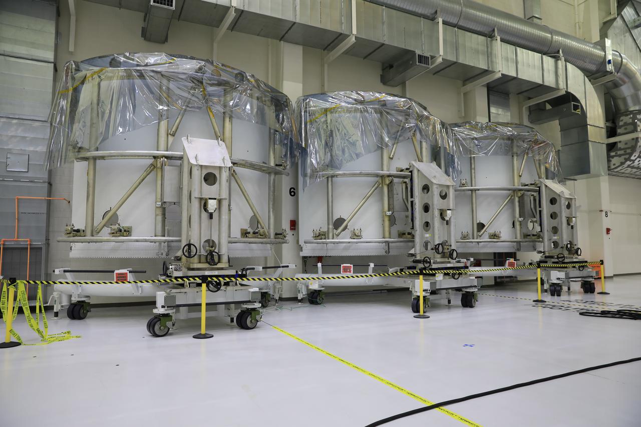 Pictured inside the Neil Armstrong Operations and Checkout Building high bay at NASA’s Kennedy Space Center in Florida on Aug. 6, 2020, are the three Spacecraft Adapter Jettison fairing panels that will protect Orion's service module from the environment around it, whether it's heat, wind or acoustics during the ascent. Unlike conventional rocket fairings, Orion's are designed to support half of the weight of the crew module and launch abort system during launch and ascent, which will maximize the size and capability of the spacecraft that can be delivered to orbit. Orion will fly on the agency’s Artemis I mission – the first in a series of increasingly complex missions to the Moon that will ultimately lead to the exploration of Mars.