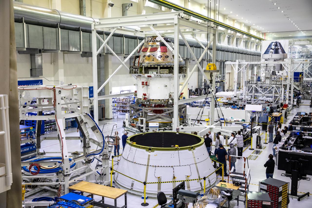 Installation of the spacecraft adapter (SA) cone to the Artemis I Orion spacecraft is in progress inside the Neil Armstrong Operations and Checkout Building at NASA’s Kennedy Space Center in Florida on Aug. 6, 2020. This is one of the final major hardware operations the spacecraft will undergo during closeout processing prior to being integrated with the Space Launch System (SLS) rocket in preparation for the first Artemis mission. The spacecraft adapter cone connects the bottom portion of Orion’s service module to the top part of the rocket known as the interim cryogenic propulsion stage (ICPS). Orion will fly on the agency’s Artemis I mission – the first in a series of increasingly complex missions to the Moon that will ultimately lead to the exploration of Mars.
