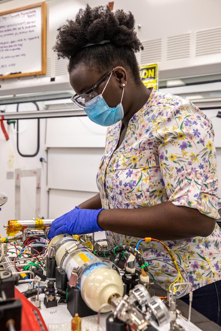 Technicians wearing protective equipment perform work for a future mission on flight hardware for NASA’s Orbital Syngas Commodity Augmentation Reactor, or OSCAR, at the Neil Armstrong Operations and Checkout Facility at the agency’s Kennedy Space Center in Florida on Aug. 10, 2020. OSCAR began as an Early Career Initiative project at the spaceport that studies technology to convert trash and human waste into useful gasses such as methane, hydrogen, and carbon dioxide. By processing small pieces of trash in a high-temperature reactor, OSCAR is advancing new and innovative technology for managing waste in space.