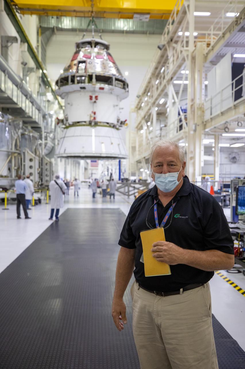 Bill Ruff, Lockheed Martin Safety manager, stands inside the Neil Armstrong Operations and Checkout Building high bay at NASA’s Kennedy Space Center in Florida on Aug. 20, 2020. Technicians are working to safely return the Artemis I Orion spacecraft to the FAST cell after completing the installation of the spacecraft adapter (SA) cone inside the high bay. This is one of the final major hardware operations the spacecraft will undergo during closeout processing prior to being integrated with the Space Launch System (SLS) rocket in preparation for the first Artemis mission. The spacecraft adapter cone connects the bottom portion of Orion’s service module to the top part of the rocket known as the interim cryogenic propulsion stage (ICPS). Orion will fly on the agency’s Artemis I mission – the first in a series of increasingly complex missions to the Moon that will ultimately lead to the exploration of Mars.
