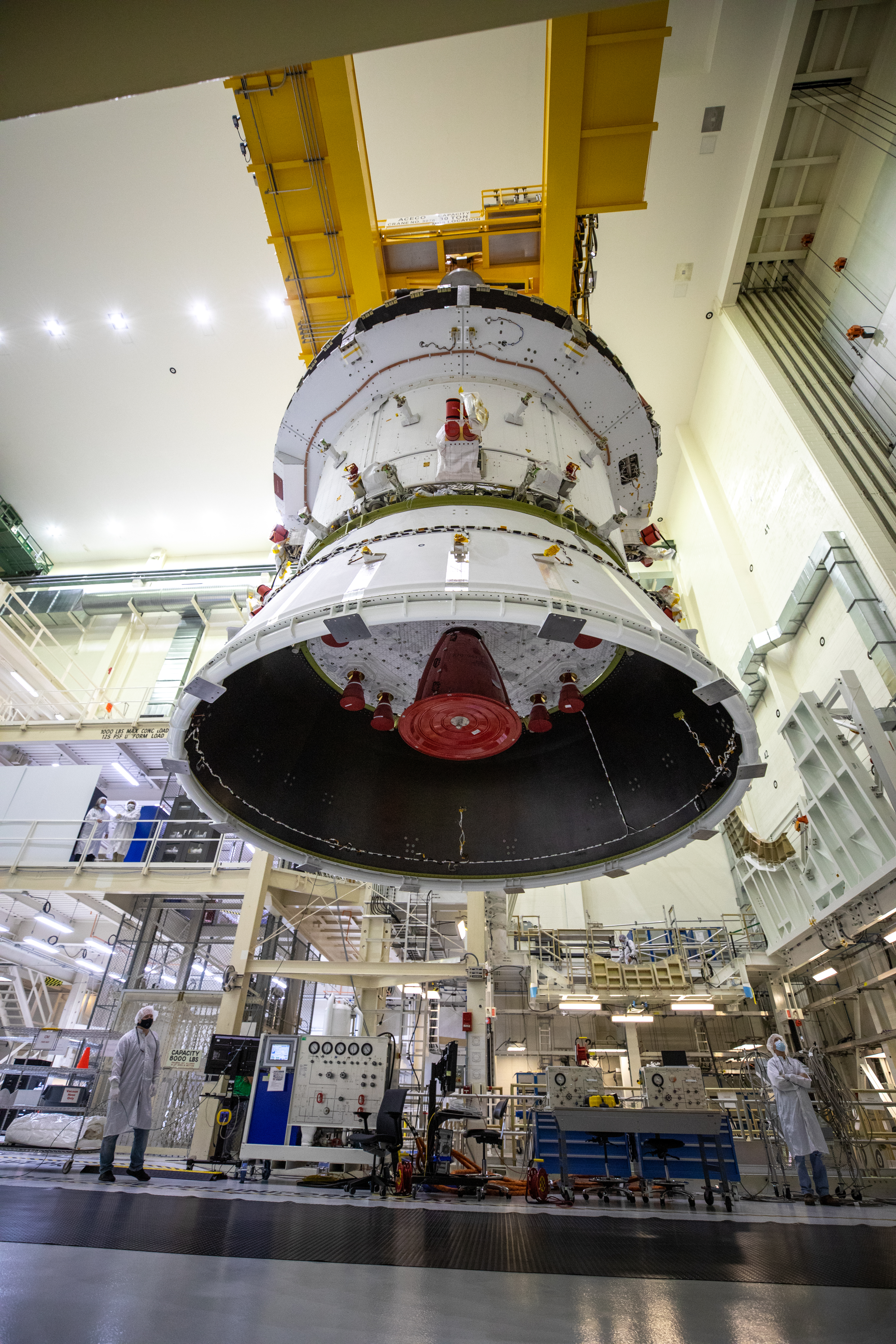 The Artemis I Orion spacecraft with its spacecraft adapter cone attached, is moved by crane along the high bay inside the Neil Armstrong Operations and Checkout Building at NASA’s Kennedy Space Center in Florida on Aug. 20, 2020. This is one of the final major hardware operations the spacecraft will undergo during closeout processing prior to being integrated with the Space Launch System (SLS) rocket in preparation for the first Artemis mission. The spacecraft adapter cone connects the bottom portion of Orion’s service module to the top part of the rocket known as the interim cryogenic propulsion stage (ICPS). Orion will fly on the agency’s Artemis I mission – the first in a series of increasingly complex missions to the Moon that will ultimately lead to the exploration of Mars.