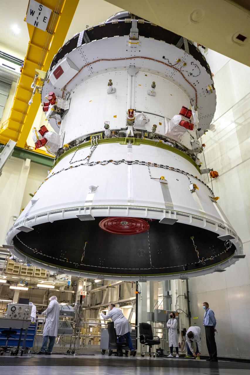 The Artemis I Orion spacecraft with its spacecraft adapter cone attached, is moved by crane along the high bay inside the Neil Armstrong Operations and Checkout Building at NASA’s Kennedy Space Center in Florida on Aug. 20, 2020. This is one of the final major hardware operations the spacecraft will undergo during closeout processing prior to being integrated with the Space Launch System (SLS) rocket in preparation for the first Artemis mission. The spacecraft adapter cone connects the bottom portion of Orion’s service module to the top part of the rocket known as the interim cryogenic propulsion stage (ICPS). Orion will fly on the agency’s Artemis I mission – the first in a series of increasingly complex missions to the Moon that will ultimately lead to the exploration of Mars.