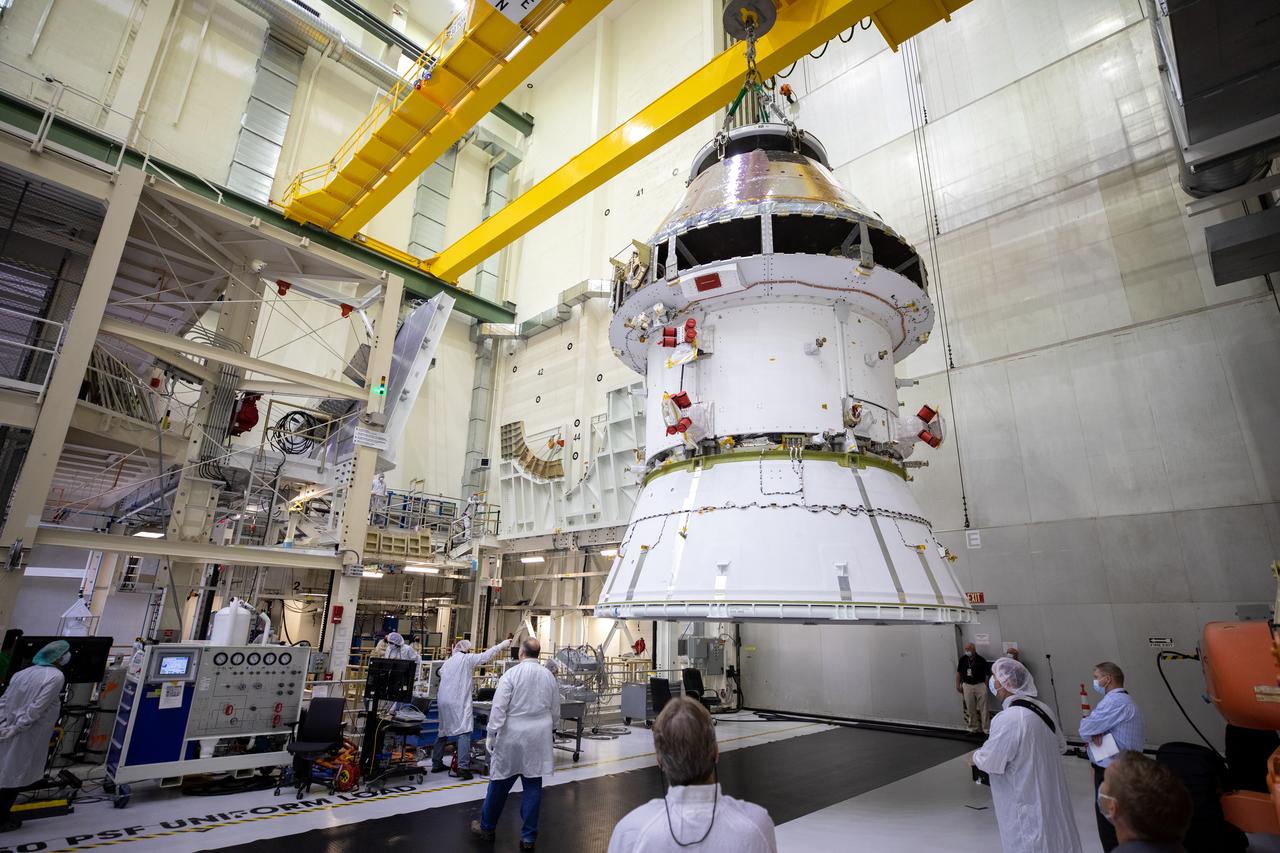 The Artemis I Orion spacecraft with its spacecraft adapter cone attached, is moved by crane along the high bay inside the Neil Armstrong Operations and Checkout Building at NASA’s Kennedy Space Center in Florida on Aug. 20, 2020. This is one of the final major hardware operations the spacecraft will undergo during closeout processing prior to being integrated with the Space Launch System (SLS) rocket in preparation for the first Artemis mission. The spacecraft adapter cone connects the bottom portion of Orion’s service module to the top part of the rocket known as the interim cryogenic propulsion stage (ICPS). Orion will fly on the agency’s Artemis I mission – the first in a series of increasingly complex missions to the Moon that will ultimately lead to the exploration of Mars.