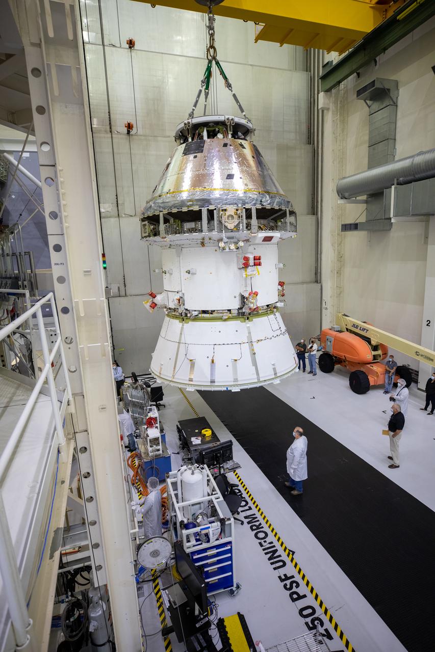 The Artemis I Orion spacecraft with its spacecraft adapter cone attached, is moved by crane along the high bay inside the Neil Armstrong Operations and Checkout Building at NASA’s Kennedy Space Center in Florida on Aug. 20, 2020. This is one of the final major hardware operations the spacecraft will undergo during closeout processing prior to being integrated with the Space Launch System (SLS) rocket in preparation for the first Artemis mission. The spacecraft adapter cone connects the bottom portion of Orion’s service module to the top part of the rocket known as the interim cryogenic propulsion stage (ICPS). Orion will fly on the agency’s Artemis I mission – the first in a series of increasingly complex missions to the Moon that will ultimately lead to the exploration of Mars.