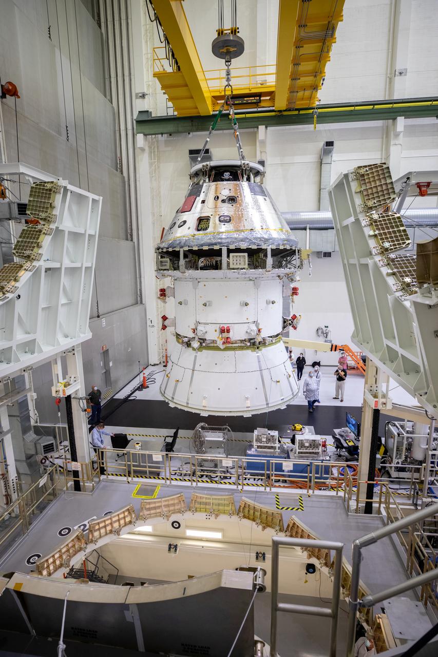 The Artemis I Orion spacecraft with its spacecraft adapter cone attached, is moved by crane into the FAST cell inside the Neil Armstrong Operations and Checkout Building at NASA’s Kennedy Space Center in Florida on Aug. 20, 2020. This is one of the final major hardware operations the spacecraft will undergo during closeout processing prior to being integrated with the Space Launch System (SLS) rocket in preparation for the first Artemis mission. The spacecraft adapter cone connects the bottom portion of Orion’s service module to the top part of the rocket known as the interim cryogenic propulsion stage (ICPS). Orion will fly on the agency’s Artemis I mission – the first in a series of increasingly complex missions to the Moon that will ultimately lead to the exploration of Mars. 