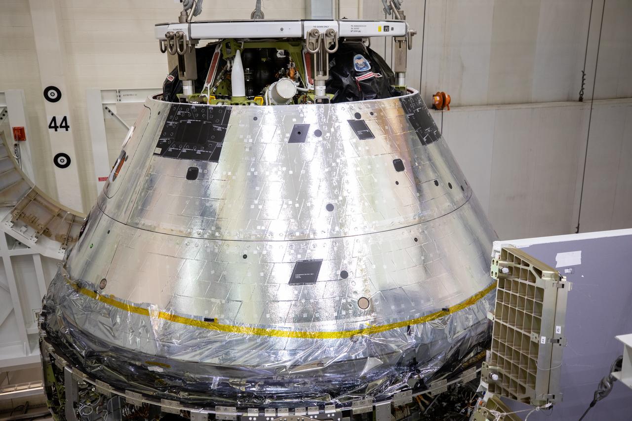 A close-up view of the Artemis I Orion spacecraft with its spacecraft adapter cone attached, is shown being lowered into the FAST cell inside the Neil Armstrong Operations and Checkout Building high bay at NASA’s Kennedy Space Center in Florida on Aug. 20, 2020. This is one of the final major hardware operations the spacecraft will undergo during closeout processing prior to being integrated with the Space Launch System (SLS) rocket in preparation for the first Artemis mission. The spacecraft adapter cone connects the bottom portion of Orion’s service module to the top part of the rocket known as the interim cryogenic propulsion stage (ICPS). Orion will fly on the agency’s Artemis I mission – the first in a series of increasingly complex missions to the Moon that will ultimately lead to the exploration of Mars.