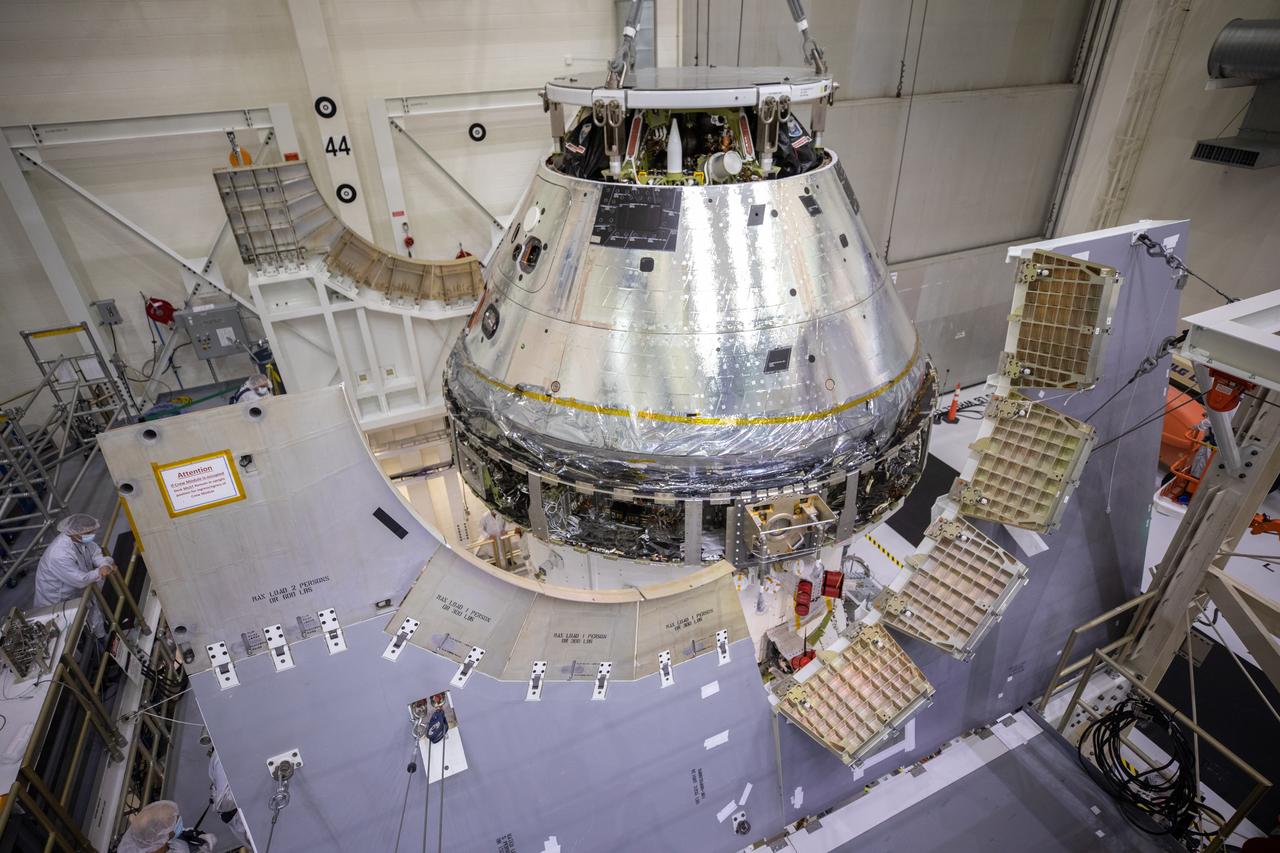 Technicians at NASA’s Kennedy Space Center in Florida work to safely lower the Artemis I Orion spacecraft into the FAST cell after completing the installation of the spacecraft adapter (SA) cone inside the Neil Armstrong Operations and Checkout Building on Aug. 20, 2020. This is one of the final major hardware operations the spacecraft will undergo during closeout processing prior to being integrated with the Space Launch System (SLS) rocket in preparation for the first Artemis mission. The spacecraft adapter cone connects the bottom portion of Orion’s service module to the top part of the rocket known as the interim cryogenic propulsion stage (ICPS). Orion will fly on the agency’s Artemis I mission – the first in a series of increasingly complex missions to the Moon that will ultimately lead to the exploration of Mars.