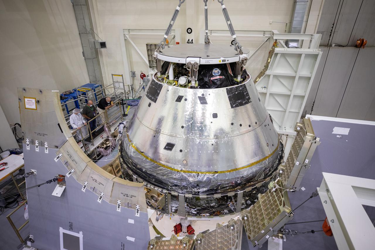 The Artemis I Orion spacecraft is lowered by crane into the FAST cell after installation of the spacecraft adapter (SA) cone was completed inside the Neil Armstrong Operations and Checkout Building on Aug. 20, 2020. This is one of the final major hardware operations the spacecraft will undergo during closeout processing prior to being integrated with the Space Launch System (SLS) rocket in preparation for the first Artemis mission. The spacecraft adapter cone connects the bottom portion of Orion’s service module to the top part of the rocket known as the interim cryogenic propulsion stage (ICPS). Orion will fly on the agency’s Artemis I mission – the first in a series of increasingly complex missions to the Moon that will ultimately lead to the exploration of Mars.