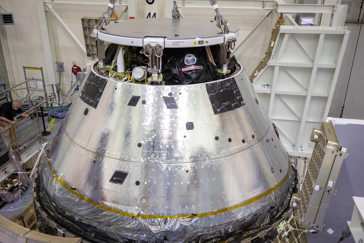 The Artemis I Orion spacecraft is lowered by crane into the FAST cell after installation of the spacecraft adapter (SA) cone was completed inside the Neil Armstrong Operations and Checkout Building on Aug. 20, 2020. This is one of the final major hardware operations the spacecraft will undergo during closeout processing prior to being integrated with the Space Launch System (SLS) rocket in preparation for the first Artemis mission. The spacecraft adapter cone connects the bottom portion of Orion’s service module to the top part of the rocket known as the interim cryogenic propulsion stage (ICPS). Orion will fly on the agency’s Artemis I mission – the first in a series of increasingly complex missions to the Moon that will ultimately lead to the exploration of Mars.