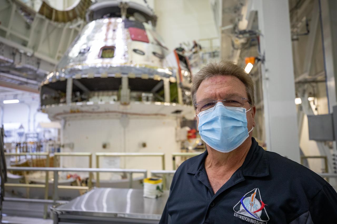 Jules Schneider, Lockheed Martin Assembly, Test and Launch Operations director, is shown inside the Neil Armstrong Operations and Checkout Building high bay in front of the FAST cell as the Artemis I Orion spacecraft is lowered by crane after installation of the spacecraft adapter (SA) cone was completed on Aug. 20, 2020. This is one of the final major hardware operations the spacecraft will undergo during closeout processing prior to being integrated with the Space Launch System (SLS) rocket in preparation for the first Artemis mission. The spacecraft adapter cone connects the bottom portion of Orion’s service module to the top part of the rocket known as the interim cryogenic propulsion stage (ICPS). Orion will fly on the agency’s Artemis I mission – the first in a series of increasingly complex missions to the Moon that will ultimately lead to the exploration of Mars.