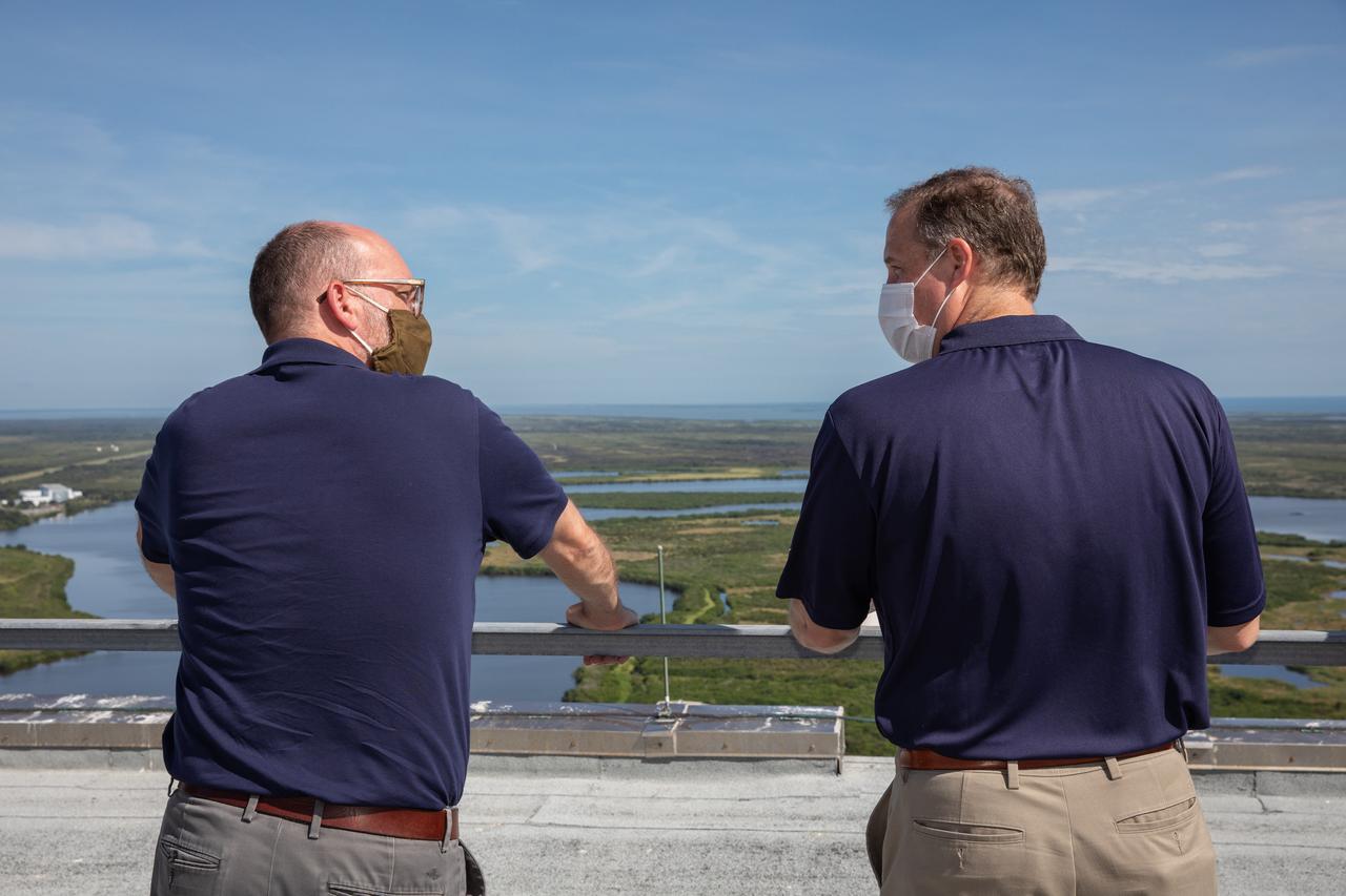 NASA Administrator Jim Bridenstine, at right, and Russell Vought, director of the White House Office of Management and Budget, are on the roof of the Vehicle Assembly Building (VAB) during a tour of the spaceport on Aug. 28, 2020. The VAB is critical to the assembly of the Space Launch System rocket for NASA’s Artemis program. The Office of Management and Budget is working with the U.S. Congress to line up the necessary resources to land the first woman and the next man on the Moon in 2024.
