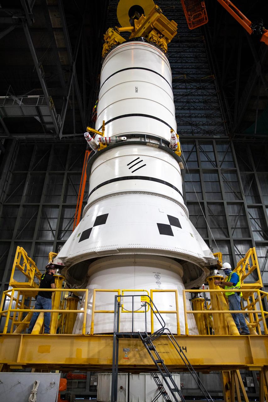 Technicians with NASA’s Exploration Ground Systems rehearse booster stacking operations inside the Vehicle Assembly Building (VAB) at the agency’s Kennedy Space Center in Florida on Sept. 11, 2020, in preparation for Artemis I. The exercise involved using booster segment mock-ups, referred to as pathfinders. During this rehearsal, an aft pathfinder segment was prepared in High Bay 4 of the VAB, after which a team of crane operators moved it over to High Bay 3, where it was placed on the mobile launcher. Stacking of the actual Space Launch System (SLS) booster segments will occur later this year, before the rocket’s core stage arrives at Kennedy. Artemis I is the first in a series of increasingly complex missions that will test SLS and the Orion spacecraft as an integrated system prior to crewed flights to the Moon.