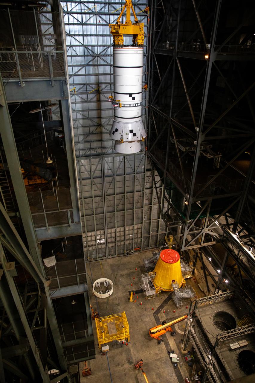 Technicians with NASA’s Exploration Ground Systems rehearse lifting operations using a mock-up of the Space Launch System (SLS) aft booster segment, referred to as a pathfinder, inside the Vehicle Assembly Building (VAB) at the agency’s Kennedy Space Center in Florida on Sept. 11, 2020, in preparation for Artemis I. The exercise involved preparing the aft pathfinder segment in High Bay 4 of the VAB and moving it over to High Bay 3, where it was placed on the mobile launcher. Stacking of the actual booster segments will occur later this year, before the SLS core stage arrives at Kennedy. Artemis I is the first in a series of increasingly complex missions that will test SLS and the Orion spacecraft as an integrated system prior to crewed flights to the Moon.