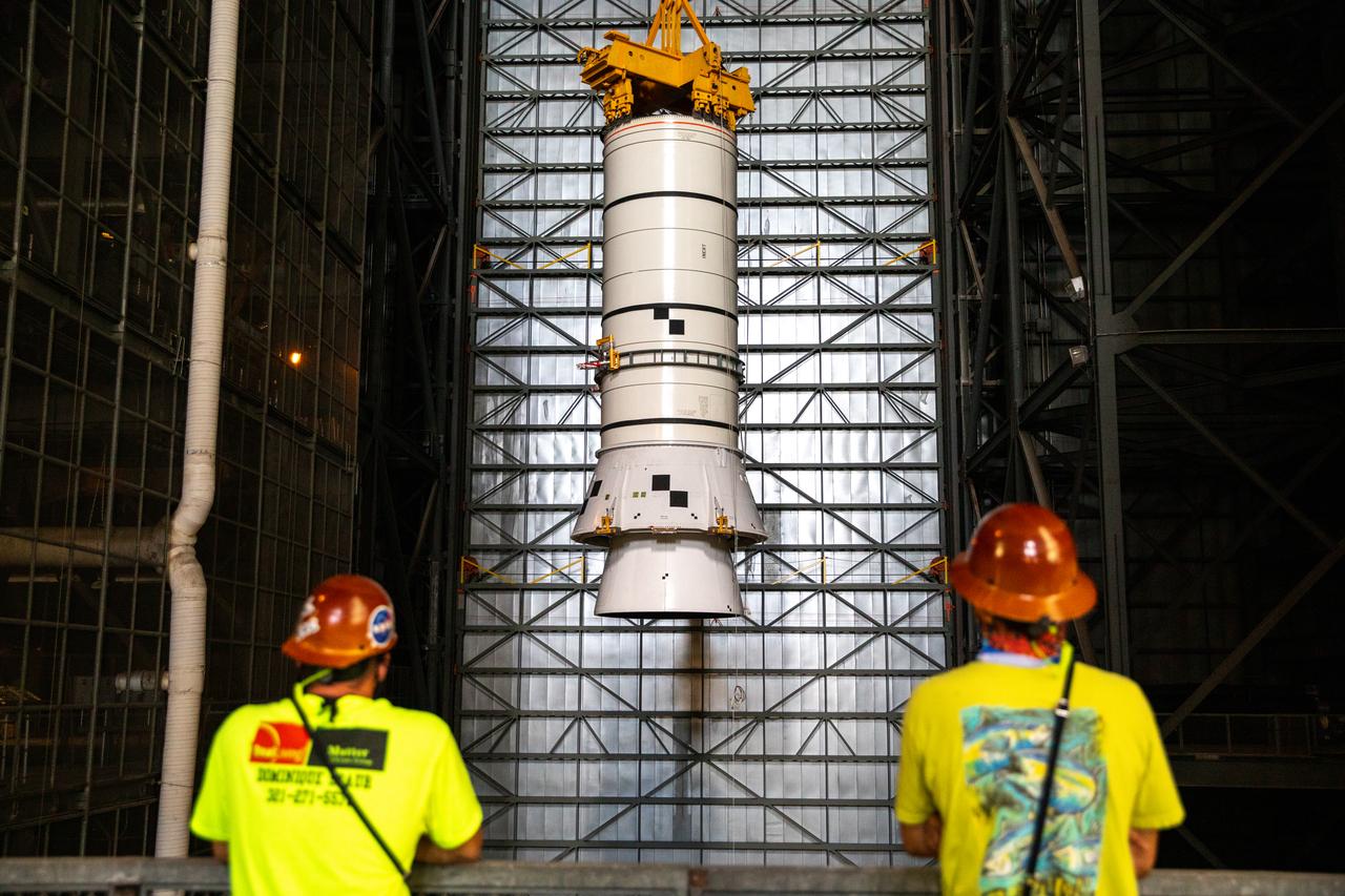 Technicians with NASA’s Exploration Ground Systems rehearse lifting operations using a mock-up of the Space Launch System (SLS) aft booster segment, referred to as a pathfinder, inside the Vehicle Assembly Building (VAB) at the agency’s Kennedy Space Center in Florida on Sept. 11, 2020, in preparation for Artemis I. The exercise involved preparing the aft pathfinder segment in High Bay 4 of the VAB and moving it over to High Bay 3, where it was placed on the mobile launcher. Stacking of the actual booster segments will occur later this year, before the SLS core stage arrives at Kennedy. Artemis I is the first in a series of increasingly complex missions that will test SLS and the Orion spacecraft as an integrated system prior to crewed flights to the Moon.