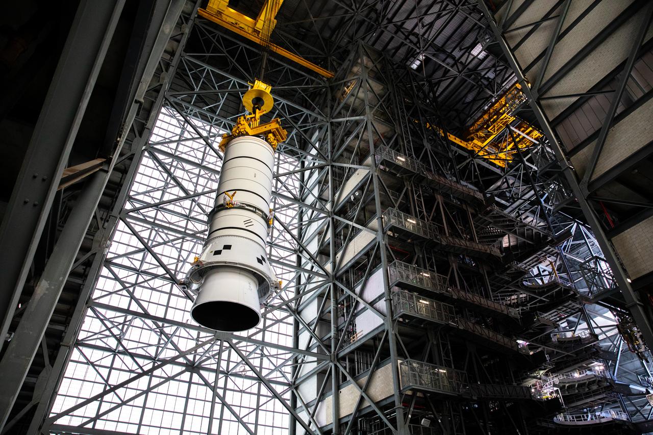 Technicians with NASA’s Exploration Ground Systems rehearse lifting operations using a mock-up of the Space Launch System (SLS) aft booster segment, referred to as a pathfinder, inside the Vehicle Assembly Building (VAB) at the agency’s Kennedy Space Center in Florida on Sept. 11, 2020, in preparation for Artemis I. The exercise involved preparing the aft pathfinder segment in High Bay 4 of the VAB and moving it over to High Bay 3, where it was placed on the mobile launcher. Stacking of the actual booster segments will occur later this year, before the SLS core stage arrives at Kennedy. Artemis I is the first in a series of increasingly complex missions that will test SLS and the Orion spacecraft as an integrated system prior to crewed flights to the Moon.
