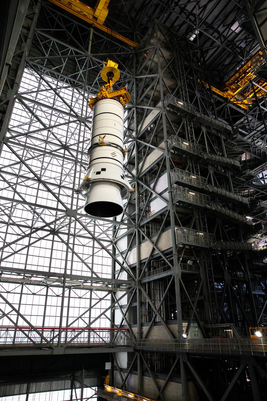 Technicians with NASA’s Exploration Ground Systems rehearse lifting operations using a mock-up of the Space Launch System (SLS) aft booster segment, referred to as a pathfinder, inside the Vehicle Assembly Building (VAB) at the agency’s Kennedy Space Center in Florida on Sept. 11, 2020, in preparation for Artemis I. The exercise involved preparing the aft pathfinder segment in High Bay 4 of the VAB and moving it over to High Bay 3, where it was placed on the mobile launcher. Stacking of the actual booster segments will occur later this year, before the SLS core stage arrives at Kennedy. Artemis I is the first in a series of increasingly complex missions that will test SLS and the Orion spacecraft as an integrated system prior to crewed flights to the Moon.