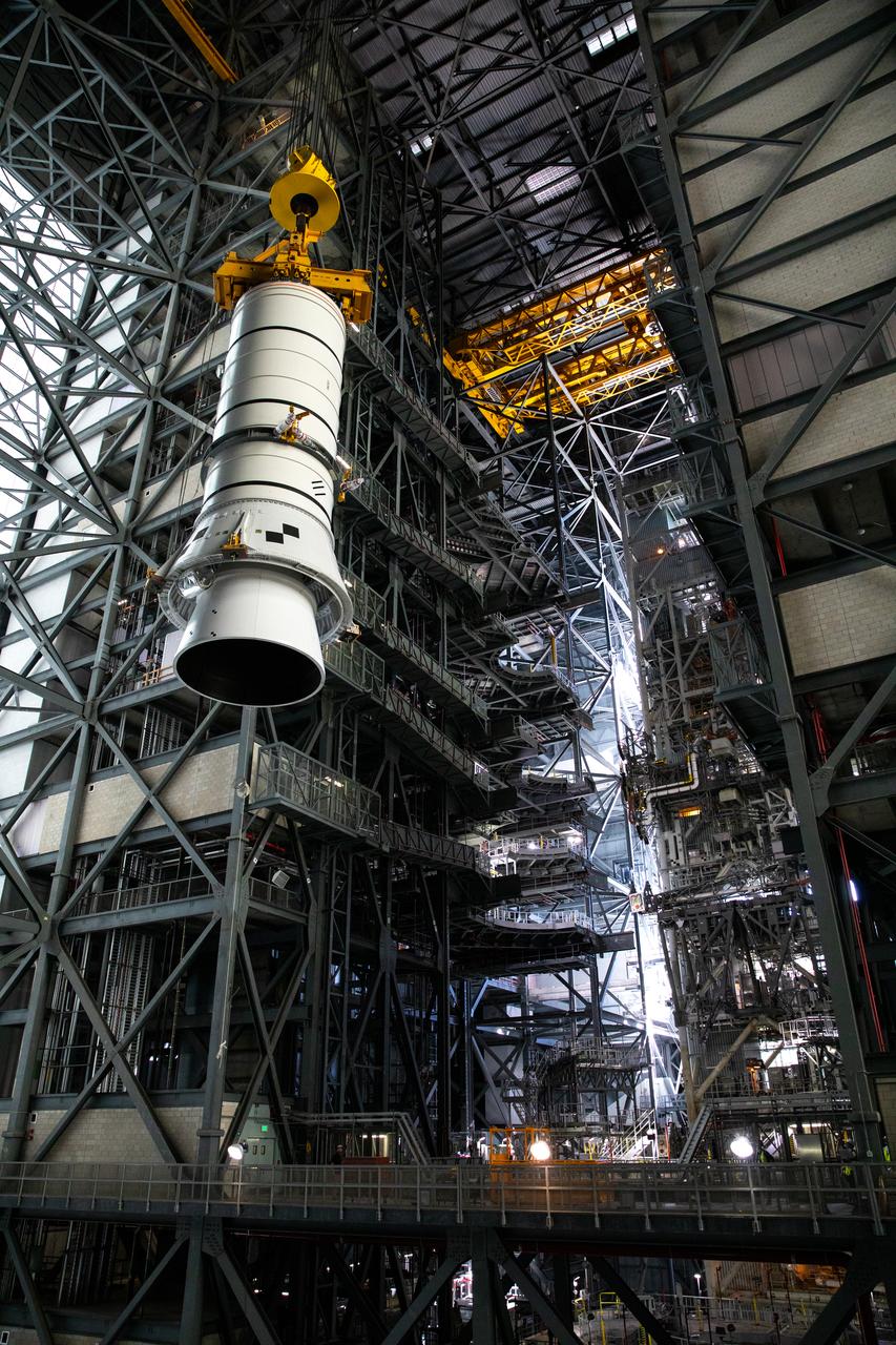 Technicians with NASA’s Exploration Ground Systems rehearse lifting operations using a mock-up of the Space Launch System (SLS) aft booster segment, referred to as a pathfinder, inside the Vehicle Assembly Building (VAB) at the agency’s Kennedy Space Center in Florida on Sept. 11, 2020, in preparation for Artemis I. The exercise involved preparing the aft pathfinder segment in High Bay 4 of the VAB and moving it over to High Bay 3, where it was placed on the mobile launcher. Stacking of the actual booster segments will occur later this year, before the SLS core stage arrives at Kennedy. Artemis I is the first in a series of increasingly complex missions that will test SLS and the Orion spacecraft as an integrated system prior to crewed flights to the Moon.