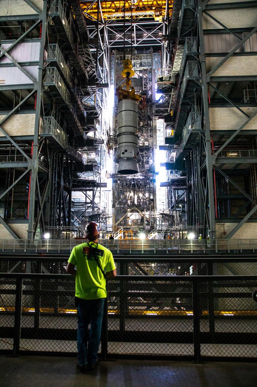 During a training exercise, technicians with NASA’s Exploration Ground Systems prepare to lower a mock-up of the Space Launch System (SLS) aft booster segment, referred to as a pathfinder, onto the mobile launcher in Kennedy Space Center’s Vehicle Assembly Building (VAB) on Sept. 11, 2020. The rehearsal involved teams preparing the aft pathfinder segment in High Bay 4 of the VAB, lifting and moving it over to High Bay 3, and placing it on the mobile launcher in preparation for Artemis I. Stacking of the actual booster segments will occur later this year, before the SLS core stage arrives at the Florida spaceport. Artemis I is the first in a series of increasingly complex missions that will test SLS and the Orion spacecraft as an integrated system prior to crewed flights to the Moon.