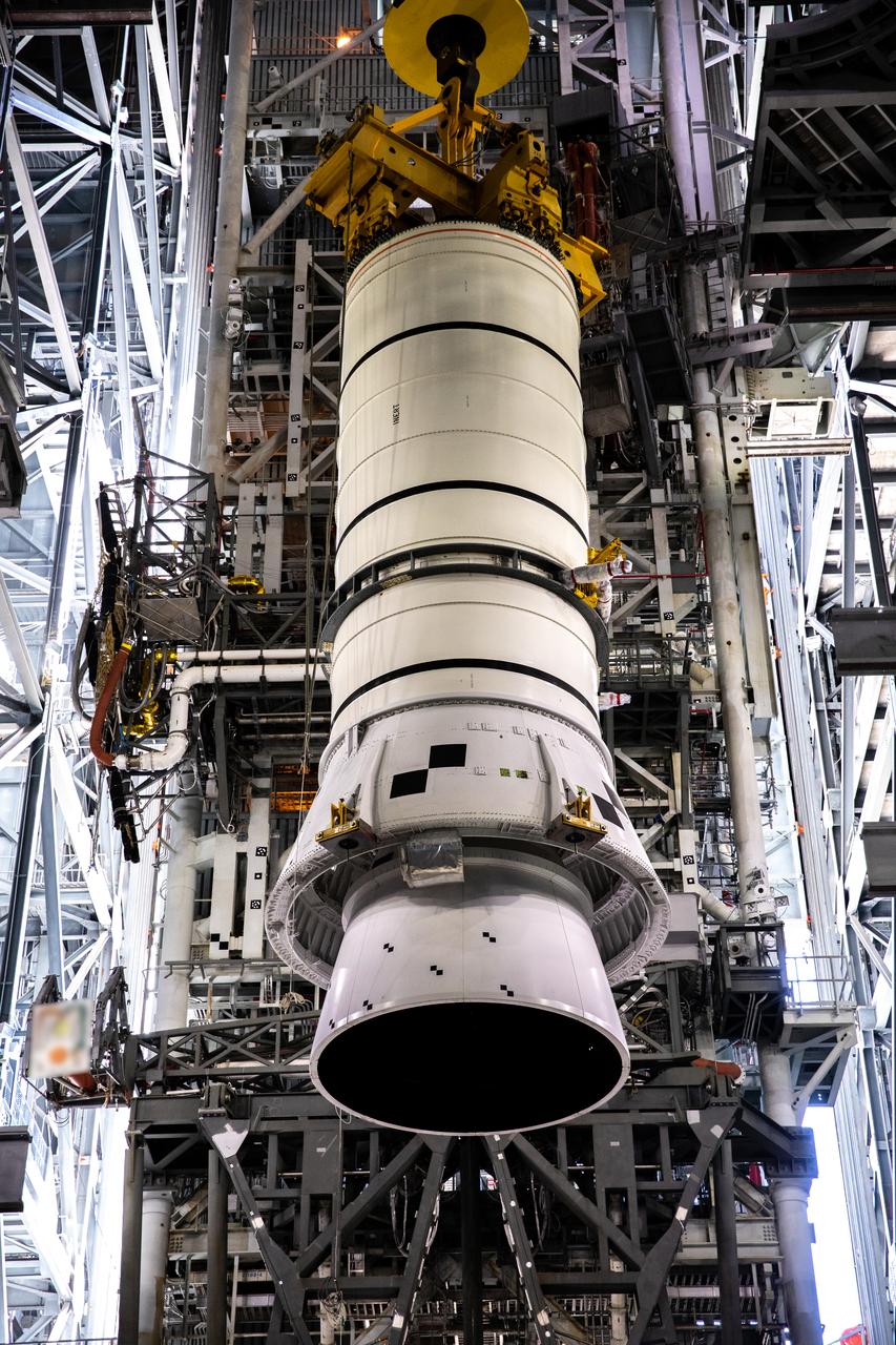 During a training exercise, technicians with NASA’s Exploration Ground Systems prepare to lower a mock-up of the Space Launch System (SLS) aft booster segment, referred to as a pathfinder, onto the mobile launcher in Kennedy Space Center’s Vehicle Assembly Building (VAB) on Sept. 11, 2020. The rehearsal involved teams preparing the aft pathfinder segment in High Bay 4 of the VAB, lifting and moving it over to High Bay 3, and placing it on the mobile launcher in preparation for Artemis I. Stacking of the actual booster segments will occur later this year, before the SLS core stage arrives at the Florida spaceport. Artemis I is the first in a series of increasingly complex missions that will test SLS and the Orion spacecraft as an integrated system prior to crewed flights to the Moon.