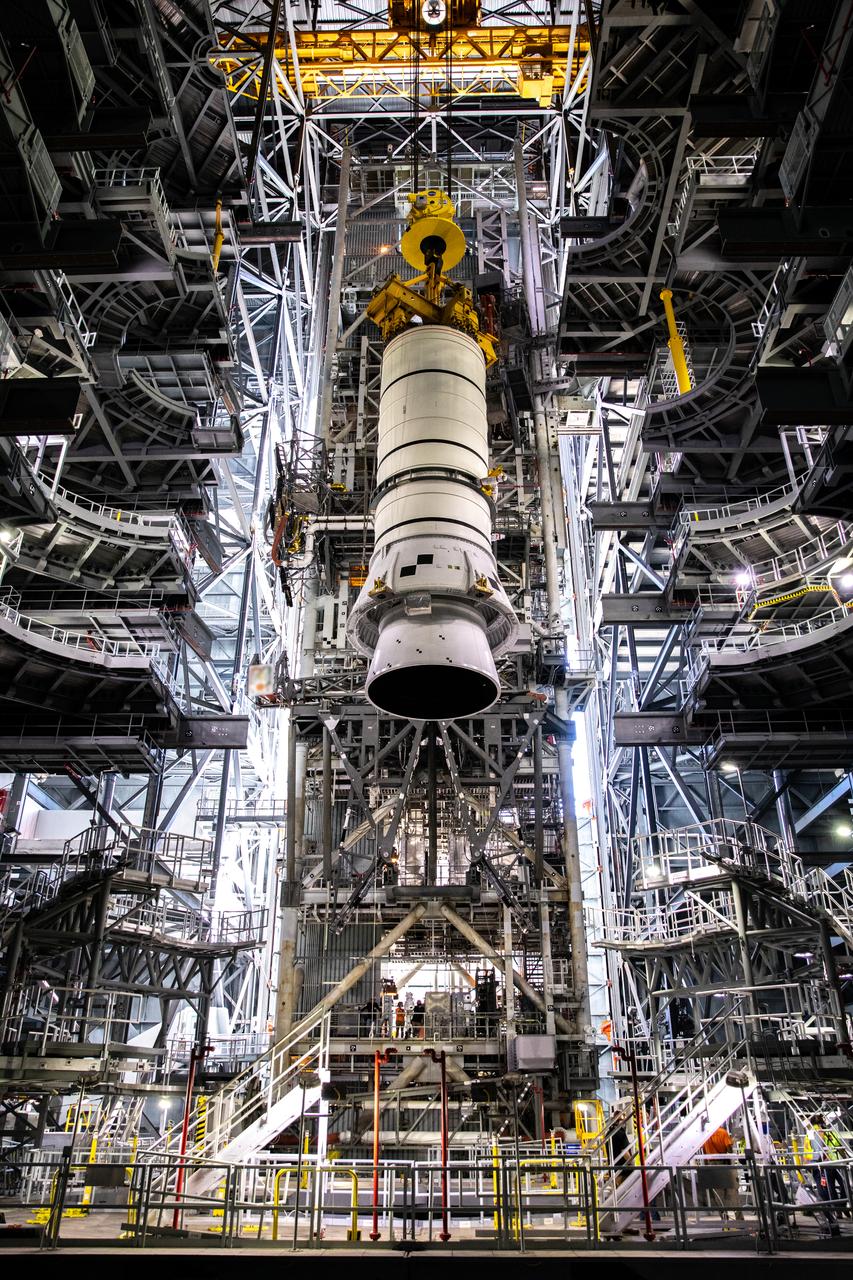 During a training exercise, technicians with NASA’s Exploration Ground Systems prepare to lower a mock-up of the Space Launch System (SLS) aft booster segment, referred to as a pathfinder, onto the mobile launcher in Kennedy Space Center’s Vehicle Assembly Building (VAB) on Sept. 11, 2020. The rehearsal involved teams preparing the aft pathfinder segment in High Bay 4 of the VAB, lifting and moving it over to High Bay 3, and placing it on the mobile launcher in preparation for Artemis I. Stacking of the actual booster segments will occur later this year, beforewhen the SLS core stage arrives at the Florida spaceport. Artemis I is the first in a series of increasingly complex missions that will test SLS and the Orion spacecraft as an integrated system prior to crewed flights to the Moon.
